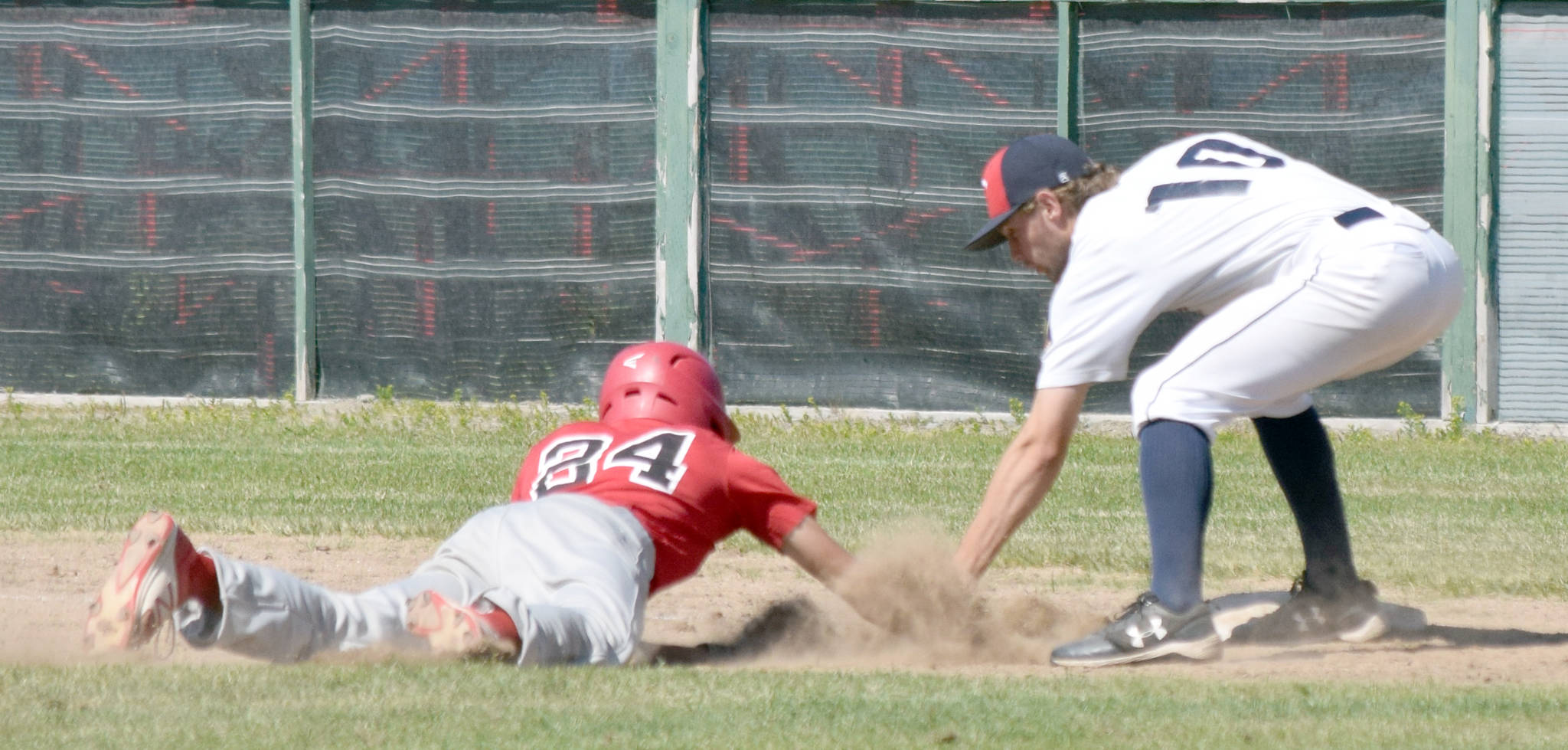 Post 20 first baseman Seth Adkins tags out Axel Shanks of Napoleon (Ohio) Post 300 on Wednesday, July 3, 2019, at Coral Seymour Memorial Park in Kenai, Alaska. Twins pitcher Mose Hayes picked off Shanks. (Photo by Jeff Helminiak/Peninsula Clarion)