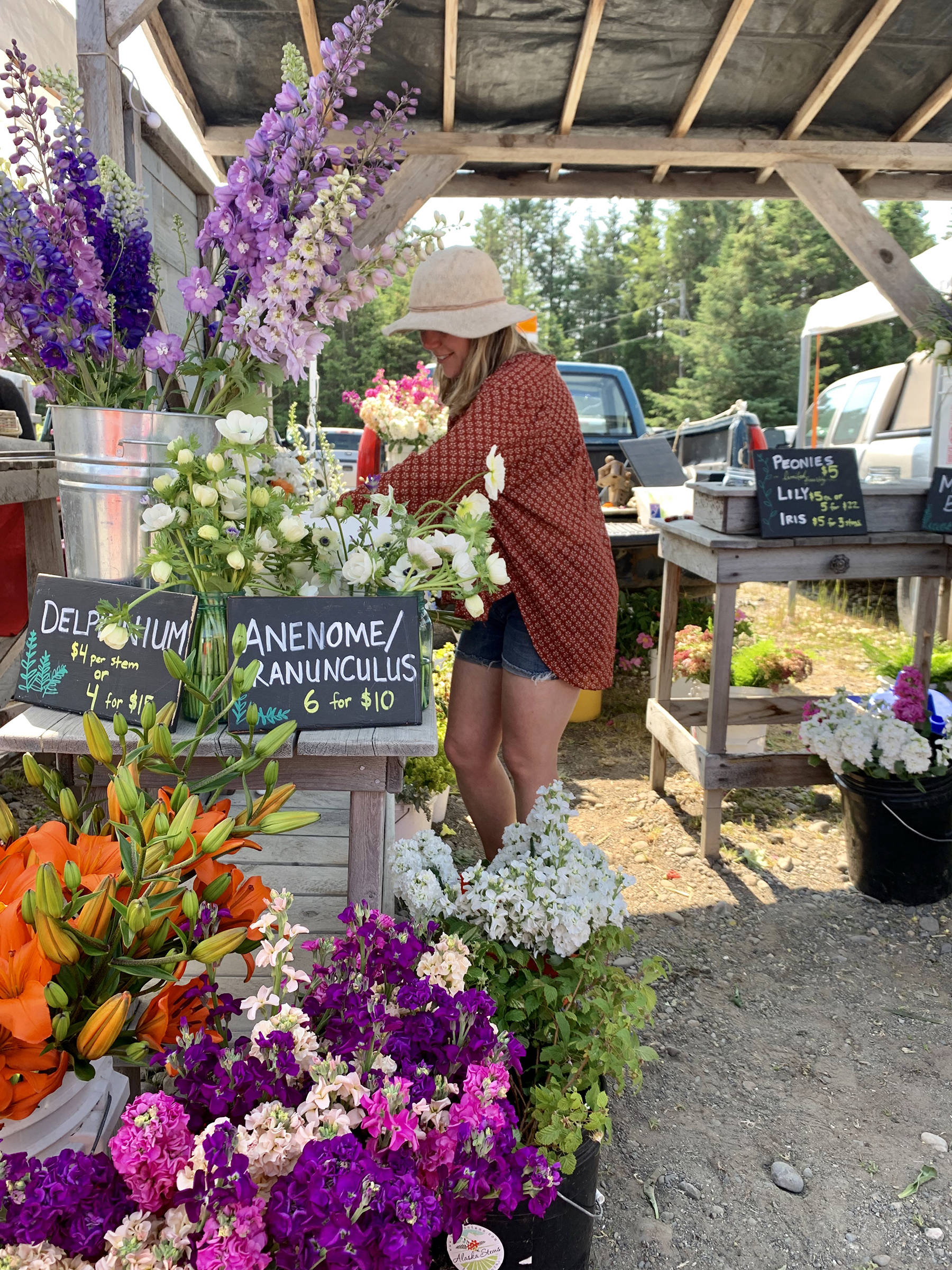 Madra Choromanska prepares freshly cut flowers for Alaska Stems on June 29, 2019, at the Homer Farmers Market in Homer, Alaska. (Photo by Sydney Leto)