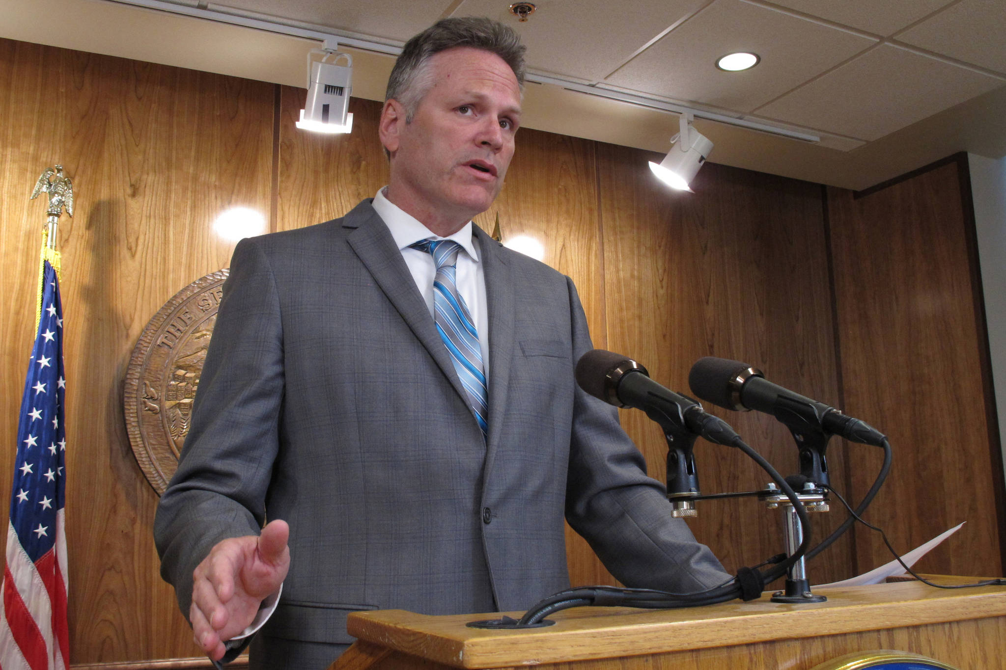 Alaska Gov. Mike Dunleavy speaks to reporters about his budget vetoes at the state Capitol in Juneau, Alaska Friday, June 28, 2019. The university system, health and social service programs and public broadcasting were among the areas affected by vetoes. The budget agreed to by the House and Senate cut state support for the university system by a fraction of what Dunleavy proposed. Lawmakers have the ability to override budget vetoes if they can muster sufficient support. (AP Photo/Becky Bohrer)