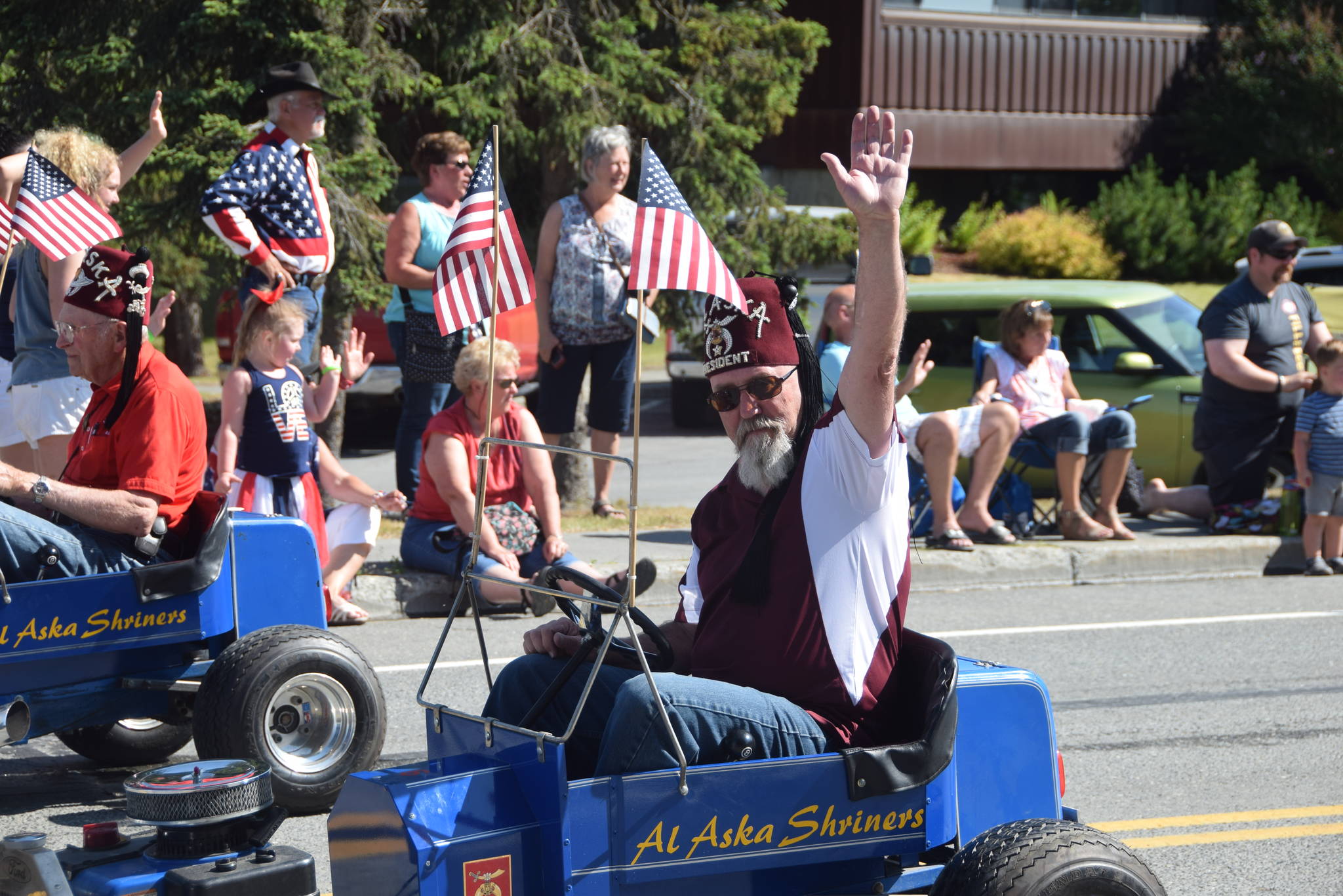One of the Alaska Shriners waves to the crowd during the July 4th parade in Kenai, Alaska. (Photo by Brian Mazurek/Peninsula Clarion)