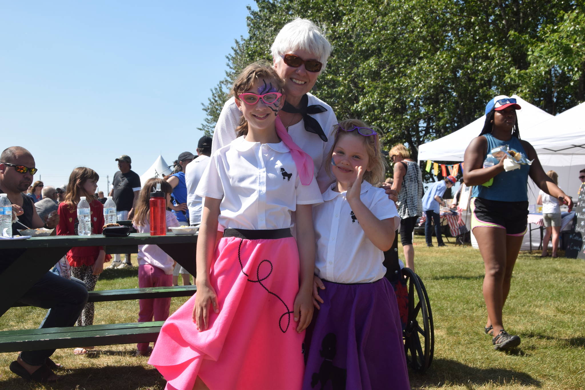 Dorothy Gray and her granddaughters Leah and Eileen Arness smile for the camera at the Kenai Park Strip during the July 4th parade in Kenai, Alaska. (Photo by Brian Mazurek/Peninsula Clarion)