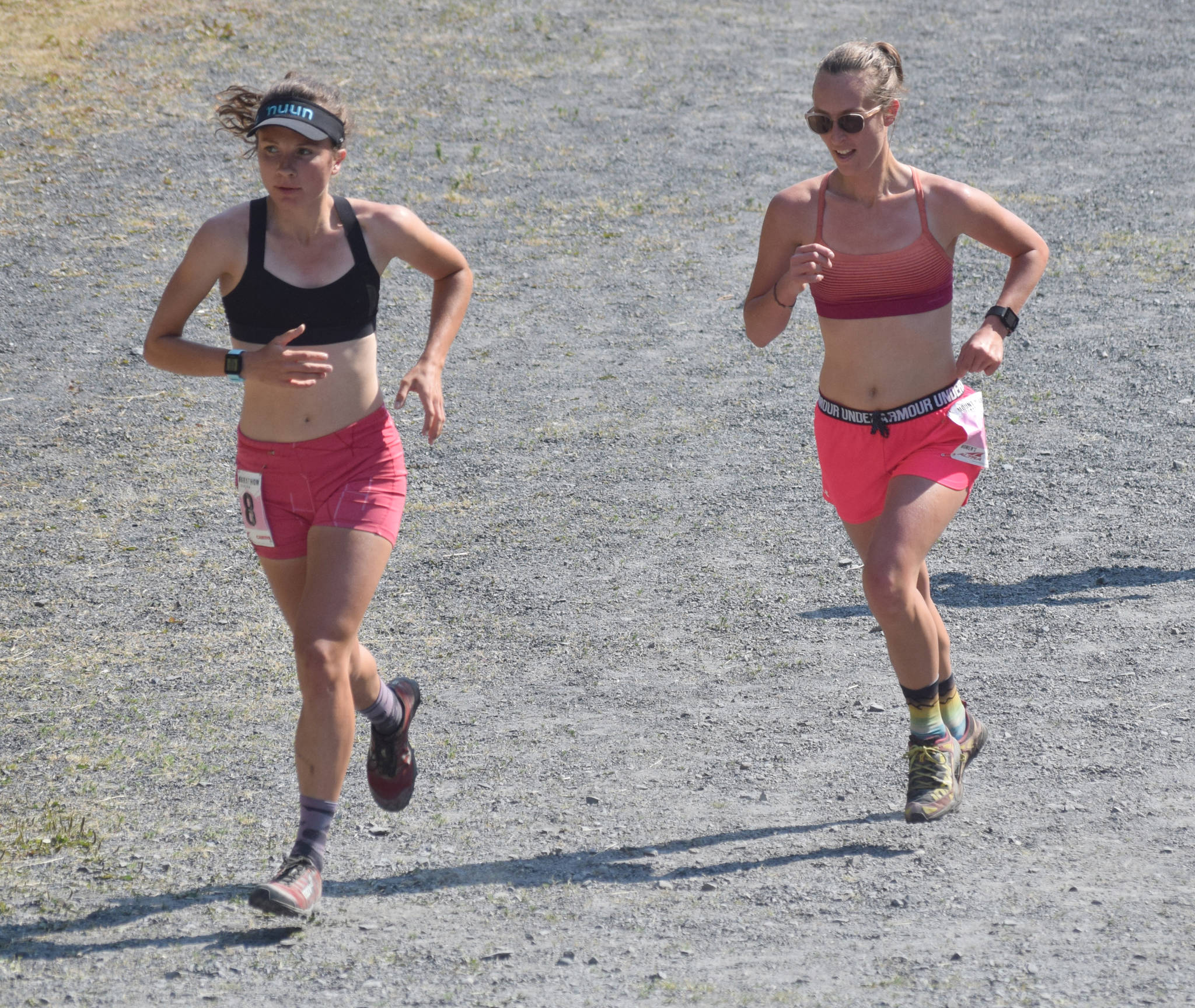 Abby Jahn of Anchorage and Allison Barnwell of Seward approach the mountain during the women’s Mount Marathon Race on Thursday, July 4, 2019, in Seward, Alaska. (Photo by Jeff Helminiak/Peninsula Clarion)