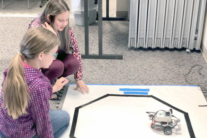 Photo by Victoria Petersen / Peninsula Clarion                                Students, Claira and Aliya, put their robot to the test June 26 in one of the many challenges in the Lego robotics UAA College of Engineering Summer Engineering Academies at the Kenai Peninsula College near Soldotna.