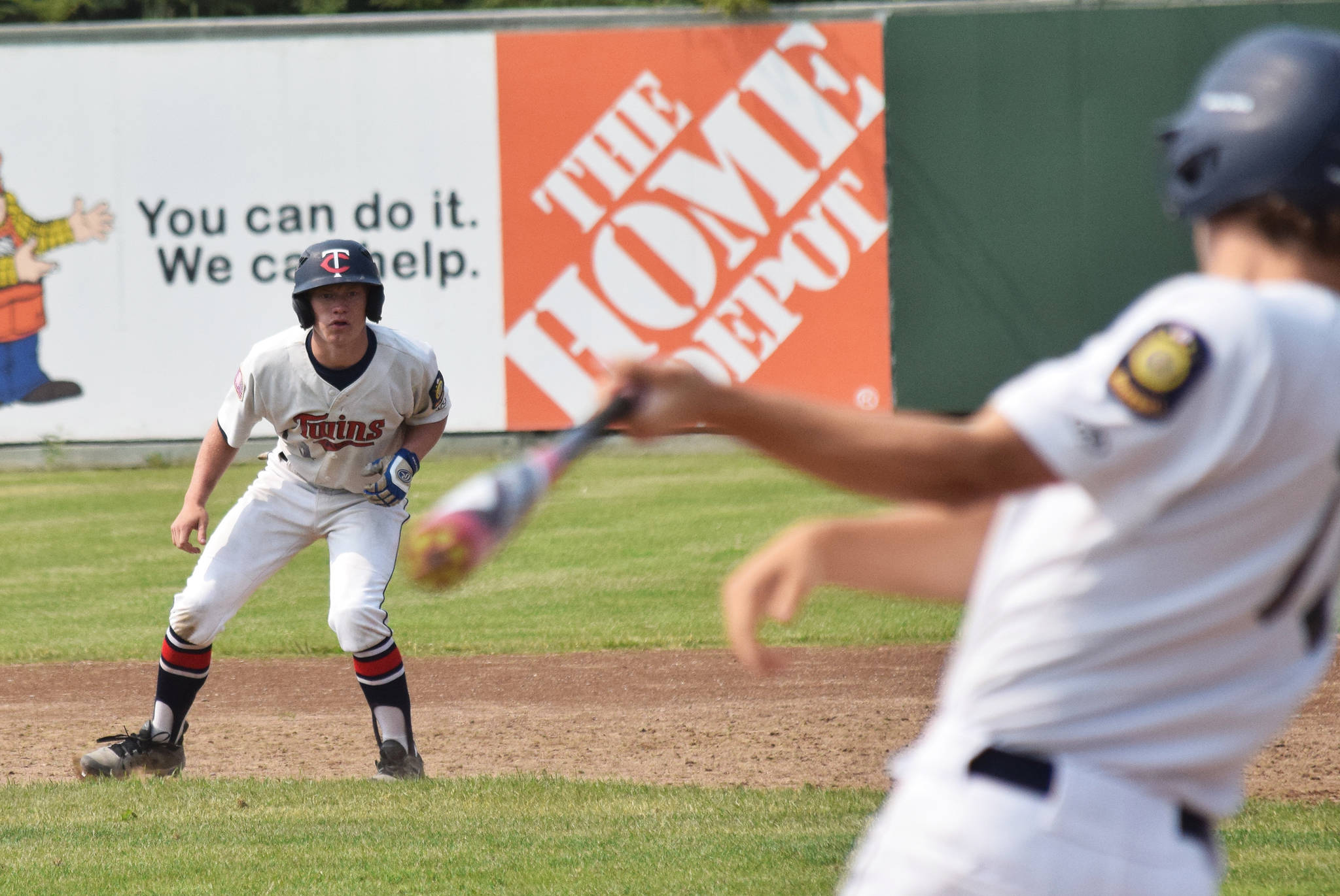 Twins baserunner Mose Hayes keeps an eye on teammate Seth Adkins Monday, July 8, 2019, against West at Coral Seymour Memorial Park in Kenai, Alaska. (Photo by Joey Klecka/Peninsula Clarion)