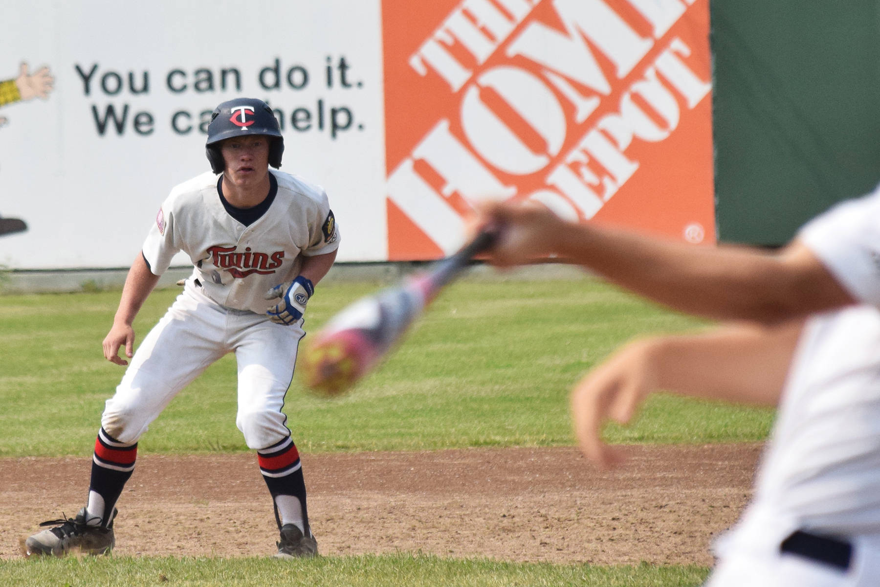 Twins go 11 innings, forge split with West