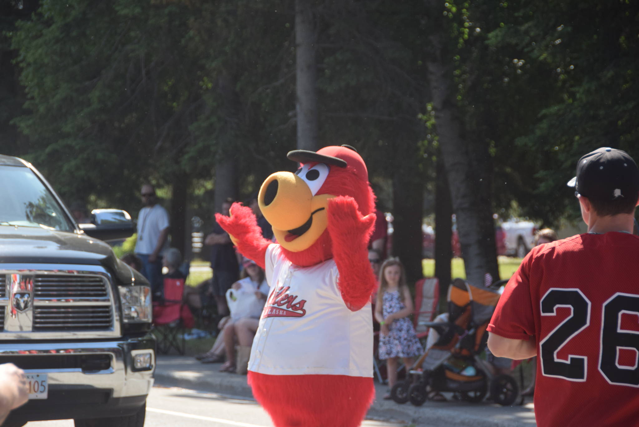 Scoop the Oilers mascot helps the police direct traffic during the 2019 July 4th parade in Kenai. The city hit an all-time high of 89 degrees. (Photo by Brian Mazurek/Peninsula Clarion)