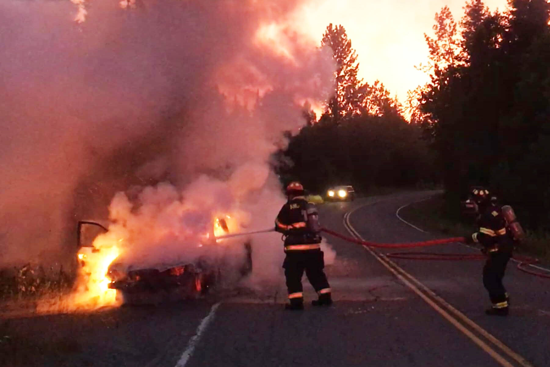 Anchor Point Fire and EMS crews put out a vehicle fire at about 11:45 p.m. Sunday, July 7, 2019, on the Old Sterling Highway near Anchor Point, Alaska. (Photo by Jon Marsh/Anchor Point Fire and EMS)