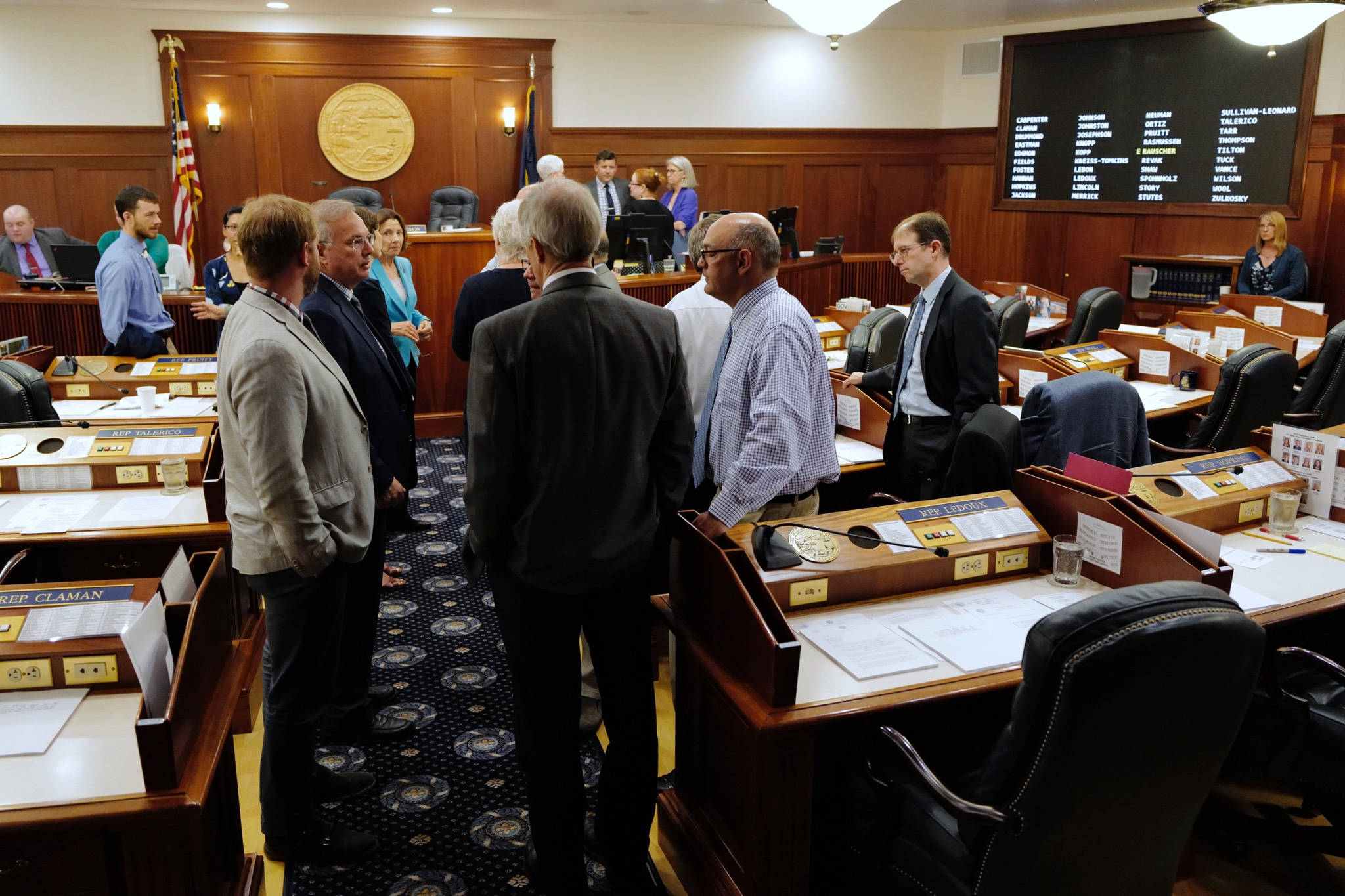 Lawmakers talk among themselves during a break of a joint session of the Alaska Legislature Thursday, July 11, 2019, in Juneau, Alaska. Lawmakers are meeting for a second day to consider overriding Gov. Mike Dunleavy’s budget vetoes, but still don’t have the needed 45 votes as about a third of lawmakers continue to meet in Wasilla instead of Juneau. (Michael Penn/The Juneau Empire via AP)