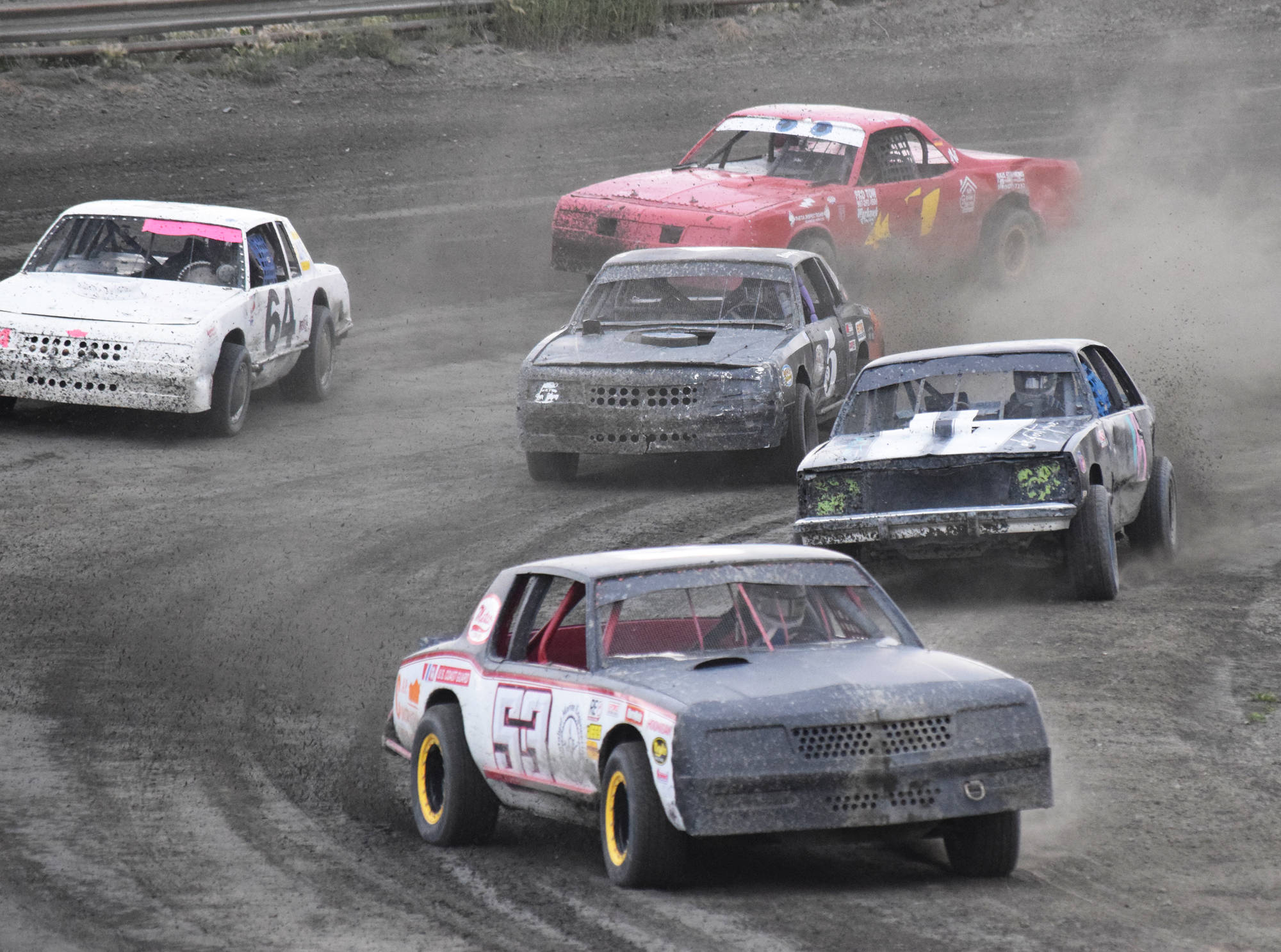 Clay Petersen leads a group of A-Stock racers around a curve Saturday, July 13, 2019, at Twin City Raceway in Kenai, Alaska. The group includes Christy Bass (left), Bridgette Attleson (middle), Mady Stichal (top) and Gracie Bass (right). (Photo by Joey Klecka/Peninsula Clarion)