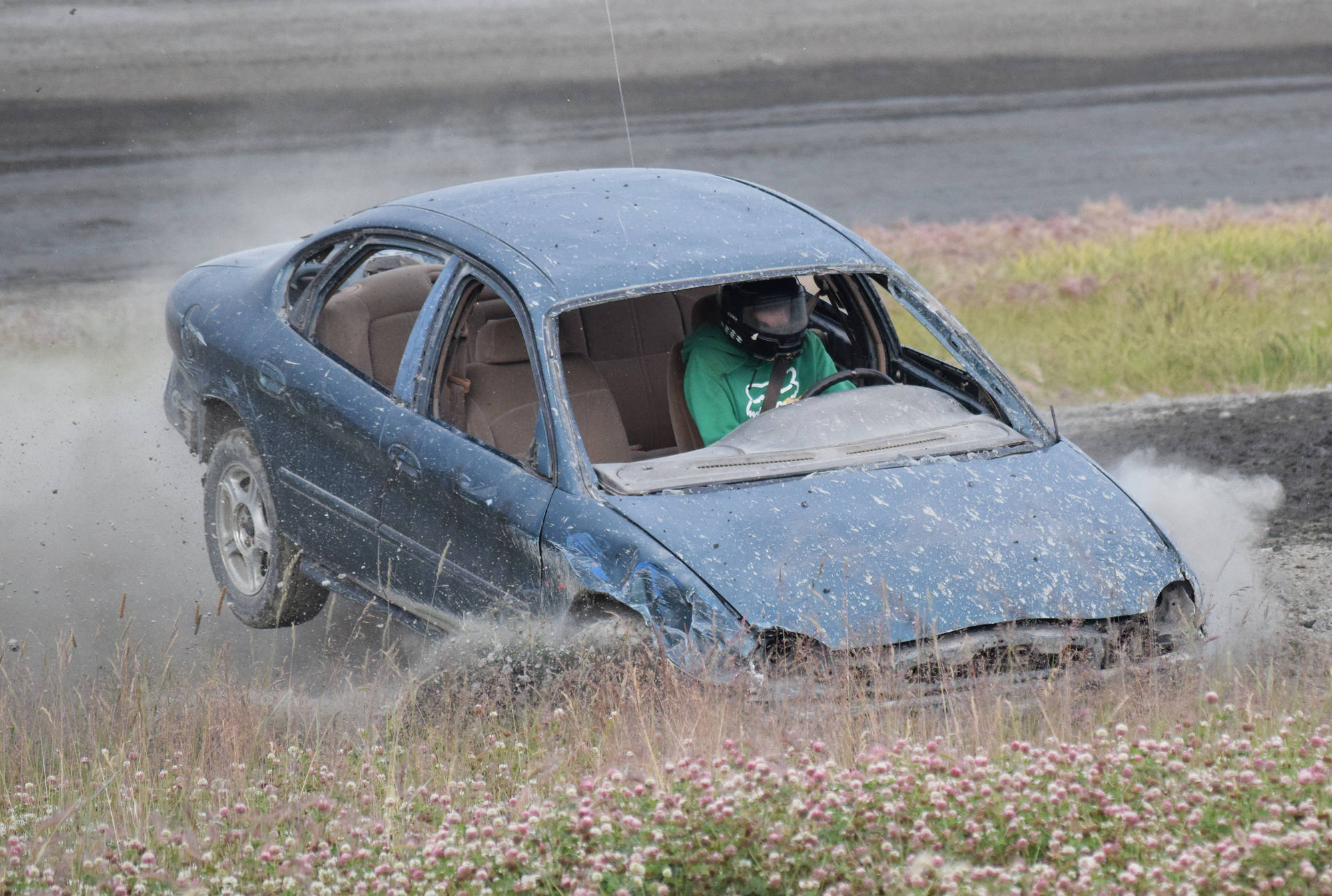 A driver in the Dollar Stock division takes a wild ride Saturday, July 13, 2019, at Twin City Raceway in Kenai, Alaska. (Photo by Joey Klecka/Peninsula Clarion)