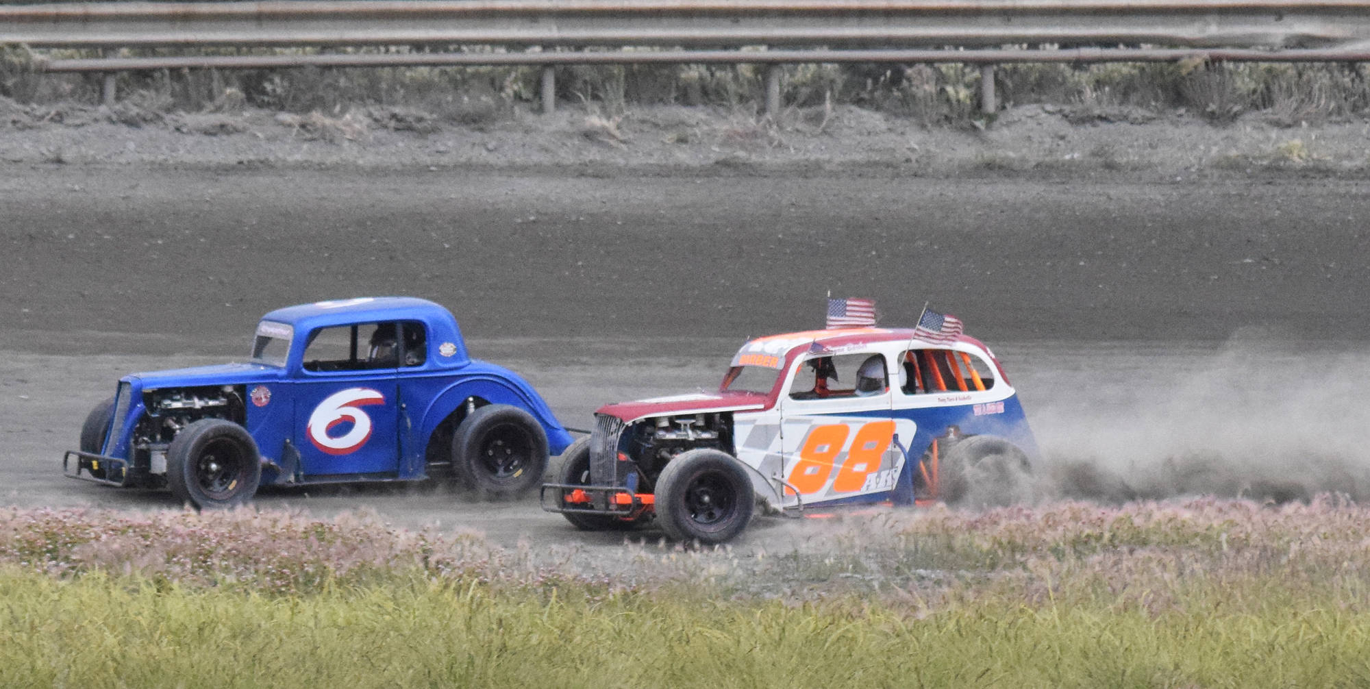 Bryan Barber (right) tries to pass Brent Romagoux Saturday, July 13, 2019, at Twin City Raceway in Kenai, Alaska. (Photo by Joey Klecka/Peninsula Clarion)