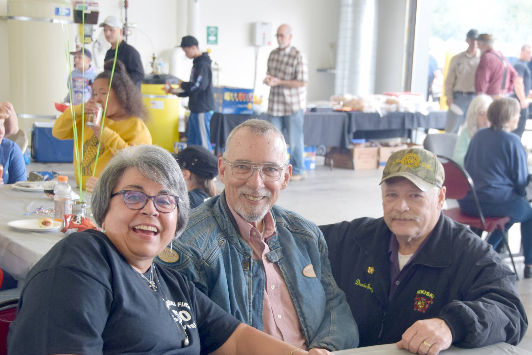 Brian Mazurek/Peninsula Clarion                                From left, Terry Carter, Dave Unruh, and Dan Gregory smile for the camera at Fire Station #2 during the Nikiski Fire Department’s 50th anniversary celebration Monday in Nikiski. Carter has been the front desk receptionist for the department for 30 years. Unruh is a retired captain and was the second person employed by the department, and Gregory was fire chief from 2000 to 2005.