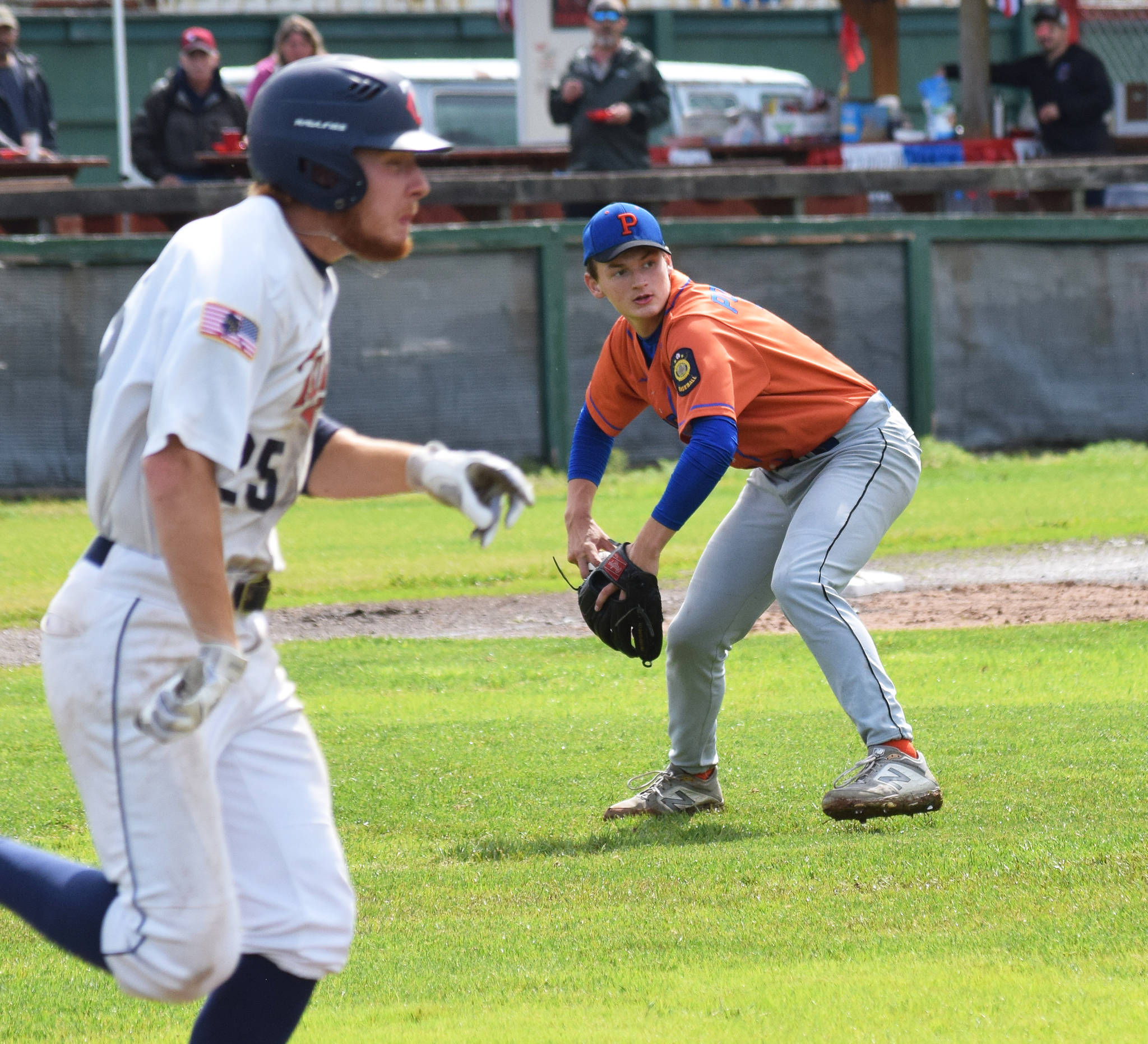 Palmer pitcher Ben Alley (right) fields a grounder by the Twins’ Jeremy Kupferschmid Tuesday, July 16, 2019, at Coral Seymour Memorial Park in Kenai, Alaska. (Photo by Joey Klecka/Peninsula Clarion)