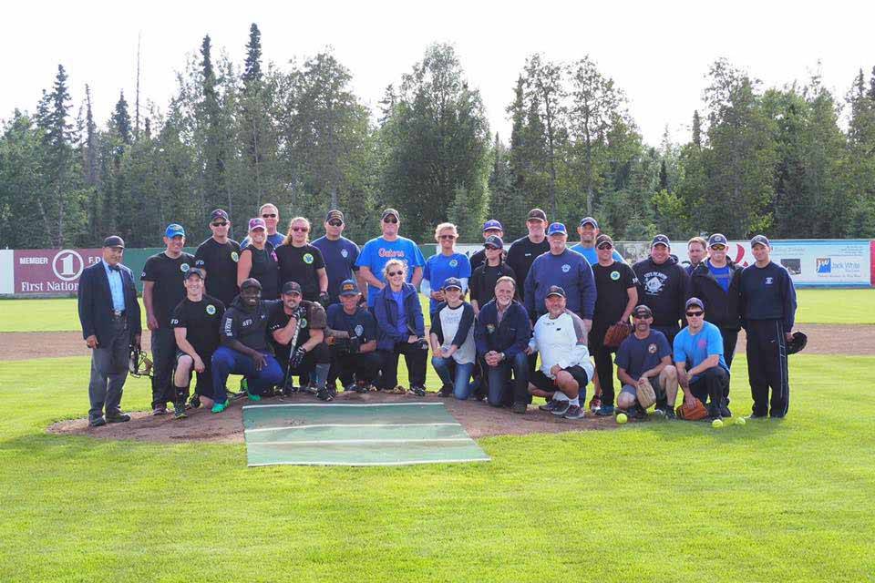 Courtesy Joe Rizzo                                 Firefighters and law enforcement officials pose during the first Guns and Hoses charity baseball game at Coral Seymour Memorial Park in Kenai in this undated photo.