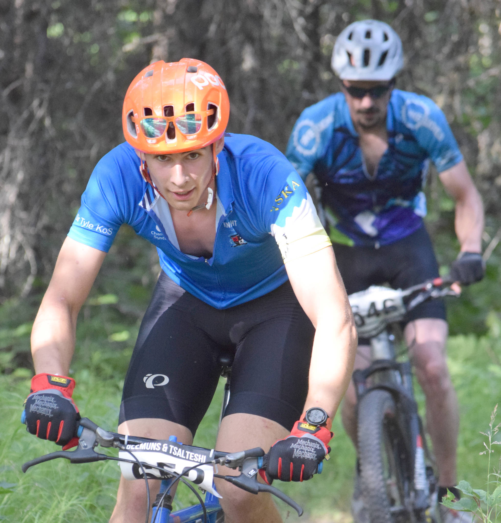 Tyle Owens leads Nathan Kincaid at Week 3 of the Soldotna Cycle Series on Thursday, July 18, 2019, at Tsalteshi Trails. (Photo by Jeff Helminiak/Peninsula Clarion)