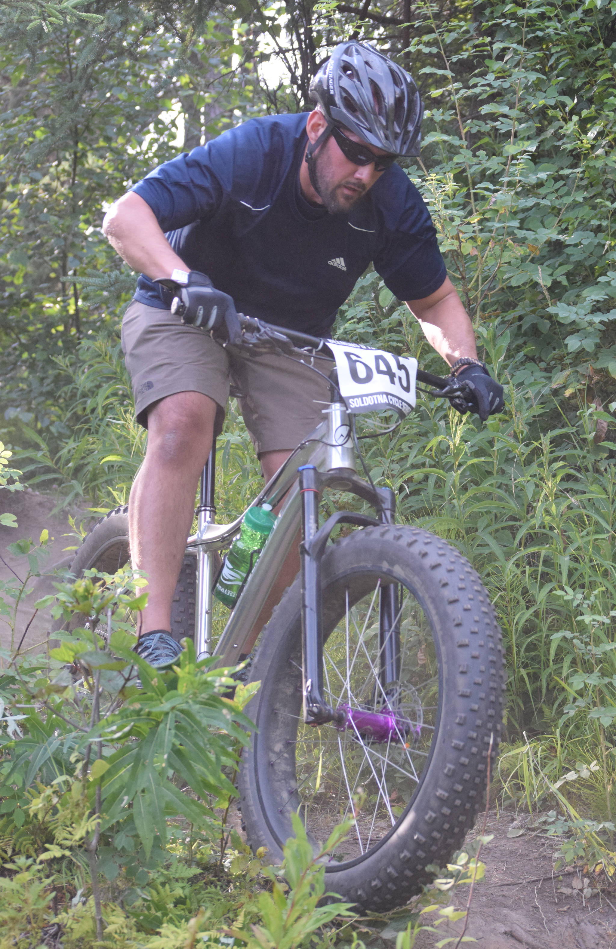 Joel Todd negotiates a drop at the Soldotna Cycle Series on Thursday, July 18, 2019, at Week 3 of the Soldotna Cycle Series at Tsalteshi Trails. (Photo by Jeff Helminiak/Peninsula Clarion)