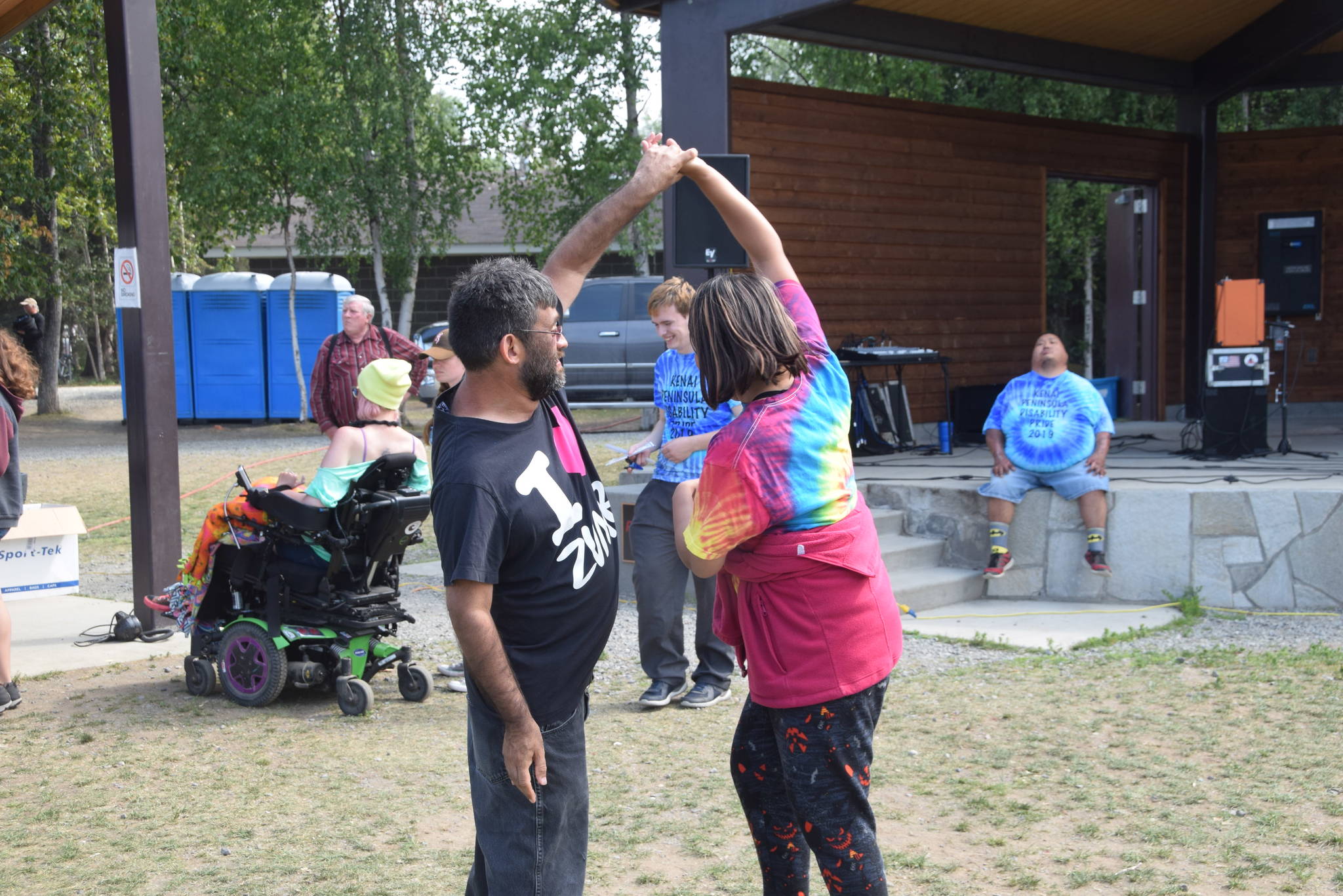 Roger Randall and Molly Joseph dance to the music of Hot Mess during the 2019 Disability Pride Celebration in Soldotna Creek Park on July 20, 2019. (Photo by Brian Mazurek/Peninsula Clarion)