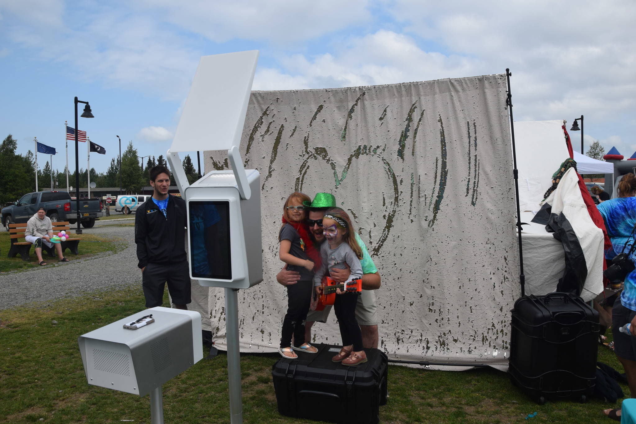 Chris Finley and his daughters Aubree and Danni pose at the photo booth during the 2019 Disability Pride Celebration in Soldotna Creek Park on July 20, 2019. (Photo by Brian Mazurek/Peninsula Clarion)