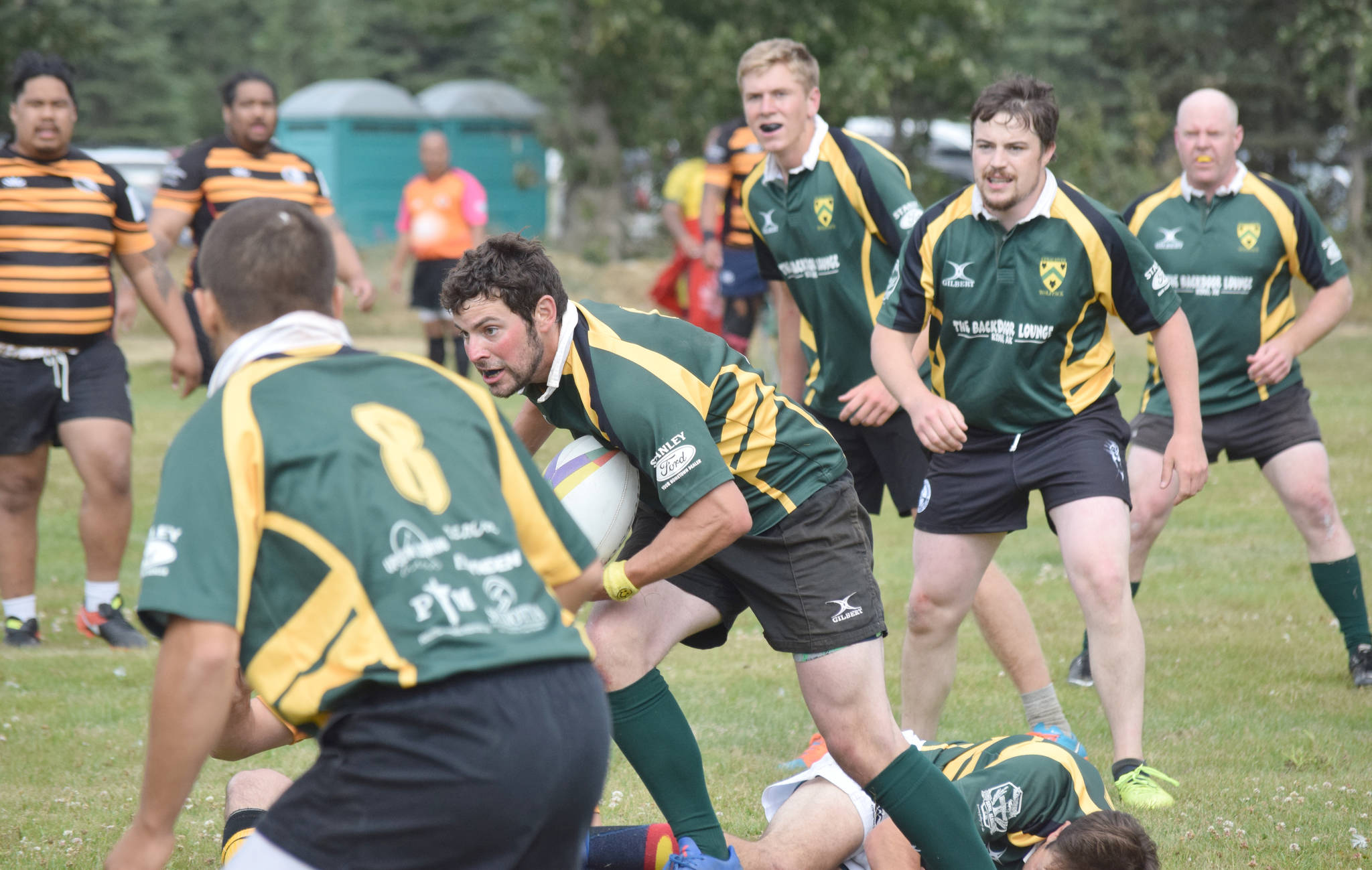 Dan Balmer of Kenai Wolfpack Rugby carries the ball Saturday, July 20, 2019, during the Kenai Dipnet Fest Rugby 10’s Tournament in Kenai. Balmer is backed by teammates, from left to right, Will Steffe, Austin Danielson and Clay Beck. (Photo by Jeff Helminiak/Peninsula Clarion)