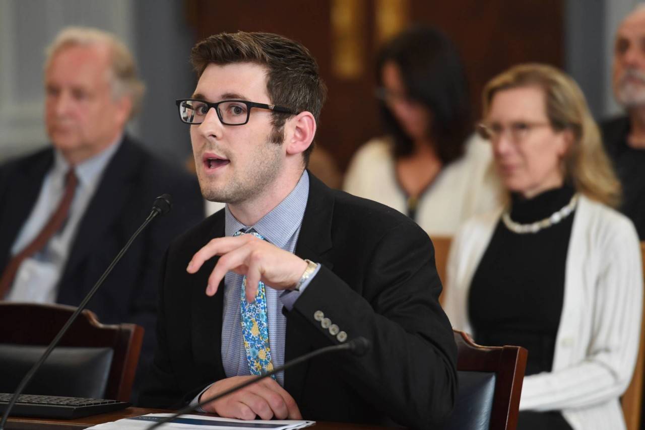 how the office performs “sweeps” of unspent money in various government accounts during a Senate Finance meeting at the Capitol on Thursday, July 18, 2019. Donna Arduin, Director of the Office of Management and Budget, right, watches in the background. (Michael Penn | Juneau Empire)