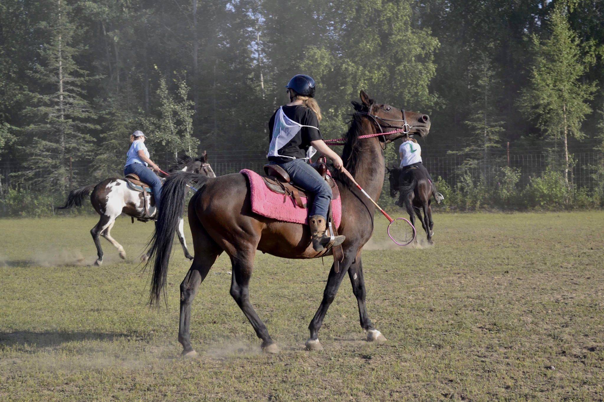Maya Johnson, the Kenai polocrosse organizer, rides her horse during a game of polocrosse, a sport combining rules of polo and lacrosse, Thursday, July, 25, 2019 near Soldotna, Alaska. (Photo by Victoria Petersen/Peninsula Clarion)