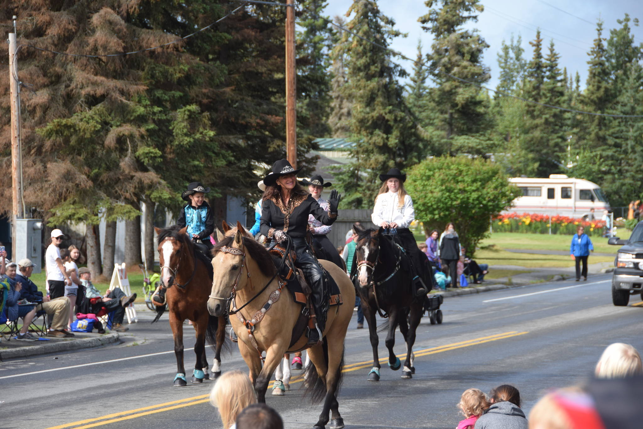 Volunteers from the Soldotna Equestrian Association wave to the crowd during Soldotna’s Progress Day Parade in Soldotna, Alaska on July 27, 2019. (Photo by Brian Mazurek/Peninsula Clarion)