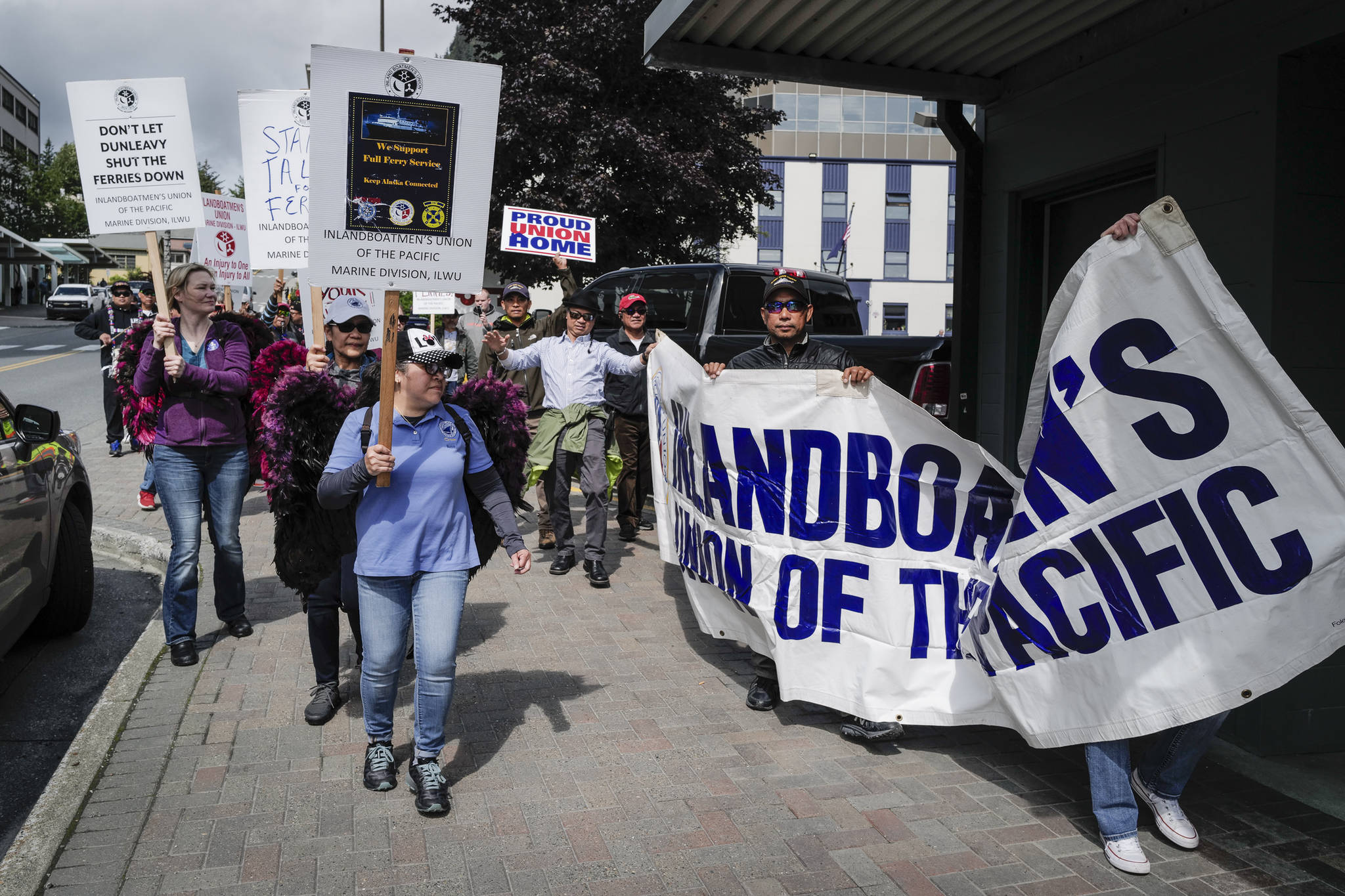 Backed by members of the Juneau Filipino community’s Ati-Atihan musical group, members of the Inland Boatmen’s Union of the Pacific march along Main Street in support of their continued strike against the Alaska Marine Highway System on Monday, July 29, 2019. (Michael Penn | Juneau Empire)