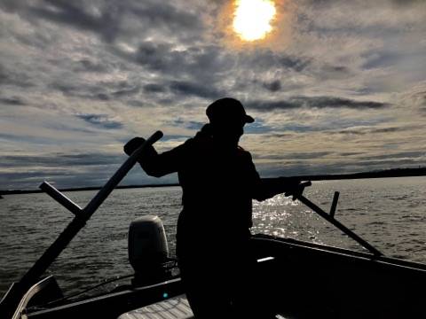 A dipnetter fishes on a boat in the Kenai River in July 2019. (Photo courtesy of Robert Valadez)