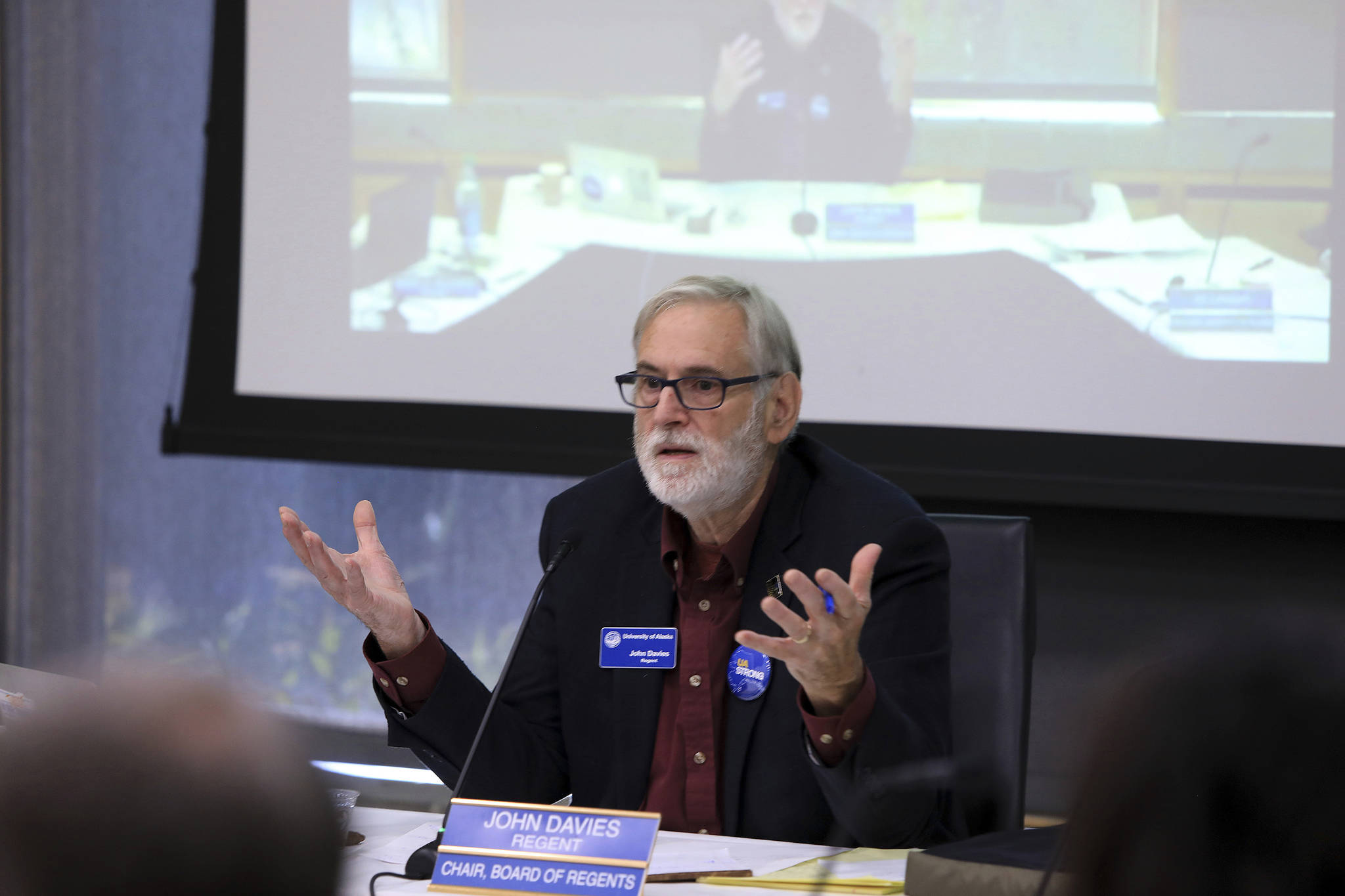 John Davies, chairman of the University of Alaska Board of Regents, speaks at a regents meeting, Tuesday, July 30, 2019, in Anchorage, Alaska. Facing severe budget cuts, regents voted 8-3 to authorize UA President Jim Johnsen to immediately reduce administrative costs and prepare a plan for a transition from three accredited institutions to one. (AP Photo/Dan Joling)