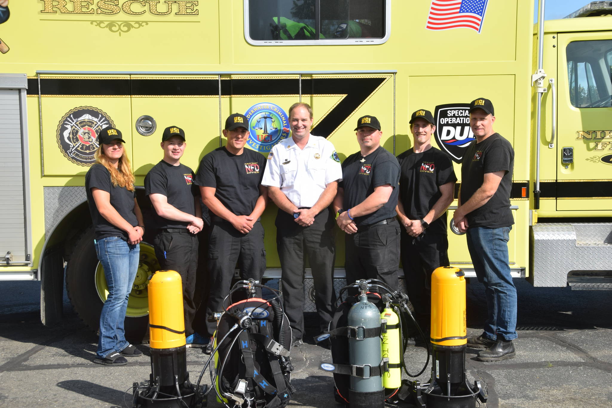 The Nikiski Fire Department’s dive team poses for a photo at the Nikiski Fire Station #1 in Nikiski, Alaska on July 29, 2019. From left: Angie Smith, TJ Cox, Kassidy Stock, Bryan Crisp, Stephen Robertson, Tyler Smith and Matt Quiner. Not present: Kole McCaughey. (Photo by Brian Mazurek/Peninsula Clarion)