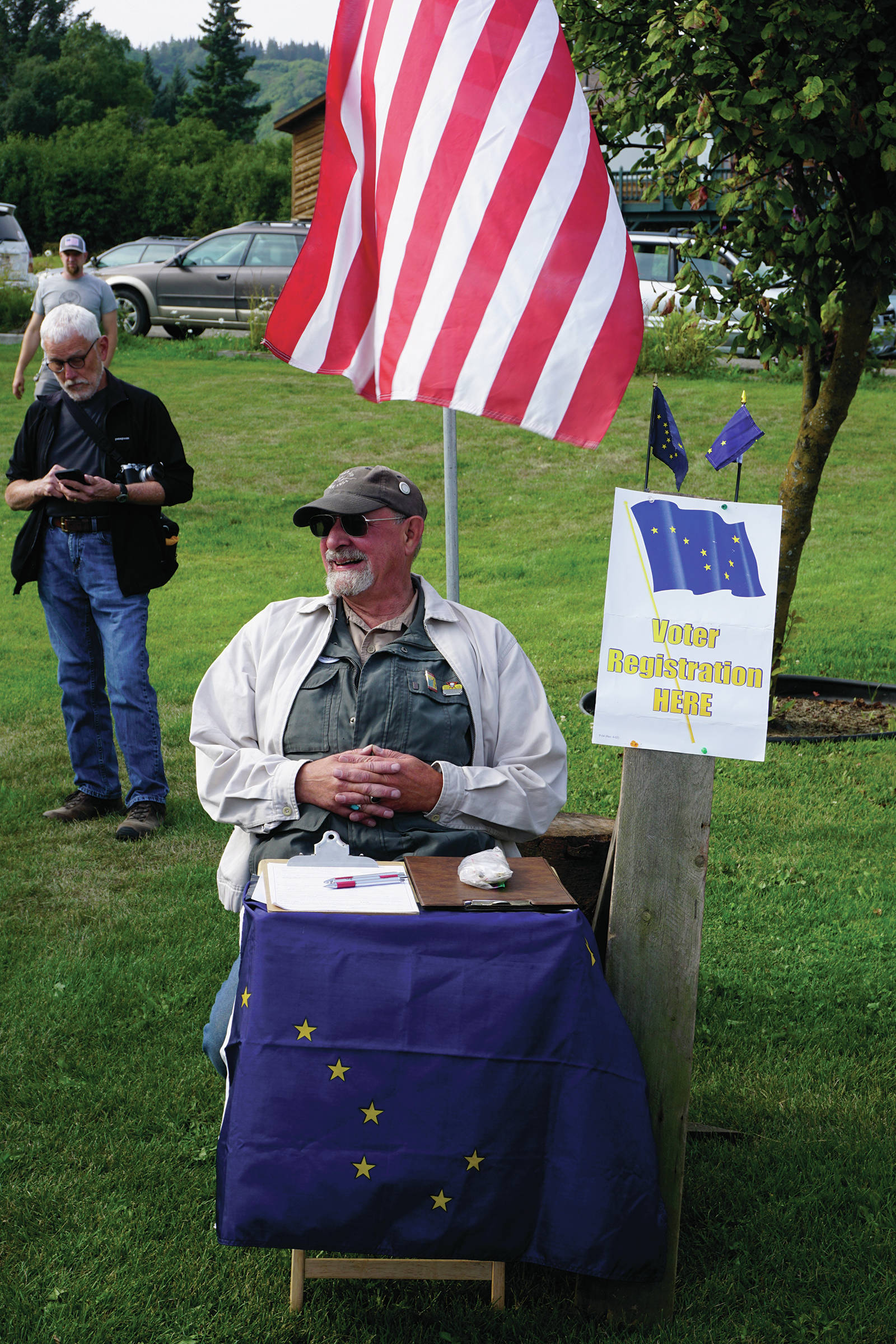 Ken Landfield staffs a voting registration table at a Recall Dunleavy rally held on Aug. 1, 2019, at WKFL Park in Homer, Alaska. Only registered Alaska voters could sign the recall petition. (Photo by Michael Armstrong)