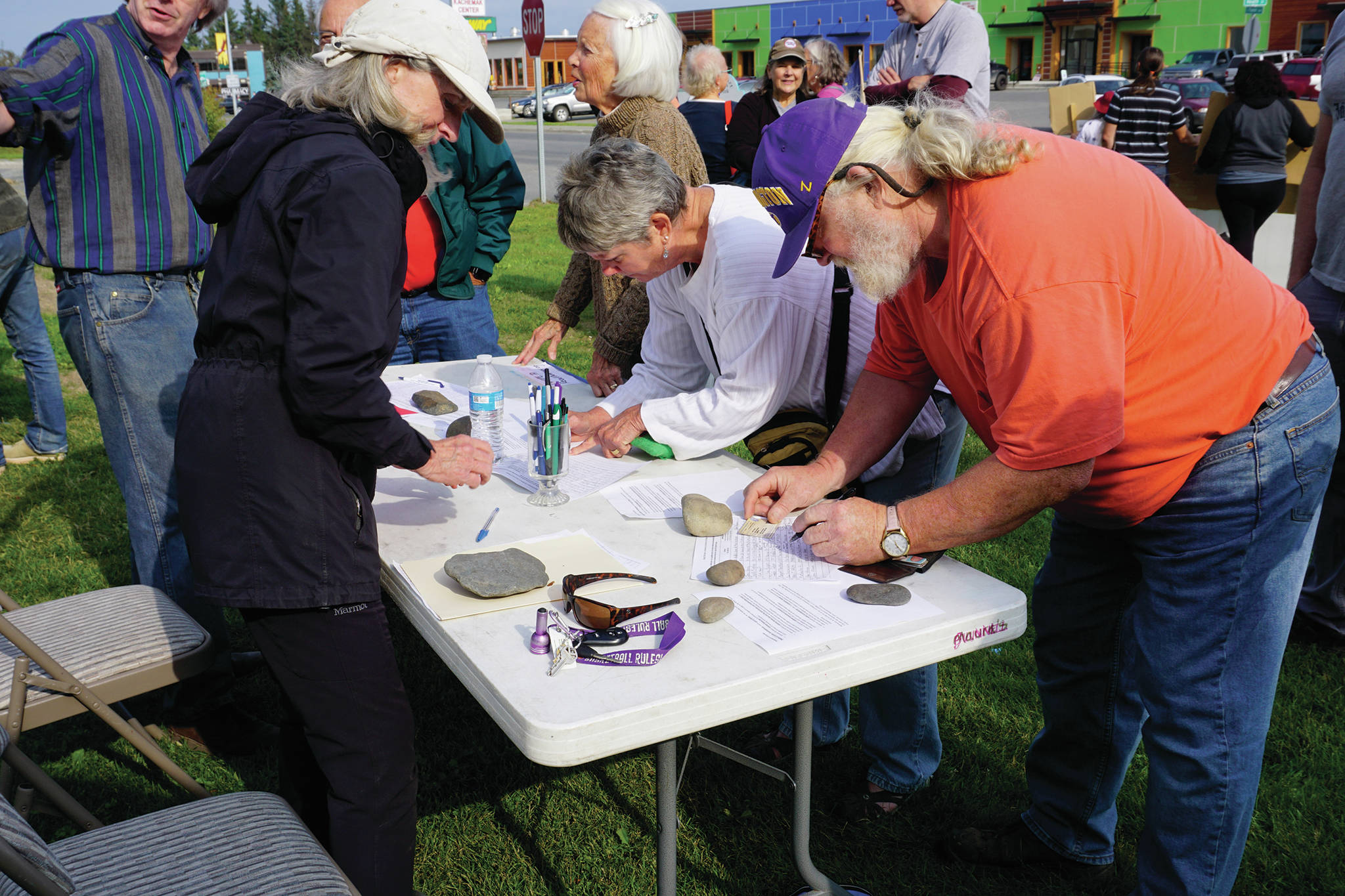 Recall Dunleavy organizer Kathy Carssow takes signatures at a Recall Dunleavy rally held on Aug. 1, 2019, at WKFL Park in Homer, Alaska. (Photo by Michael Armstrong)