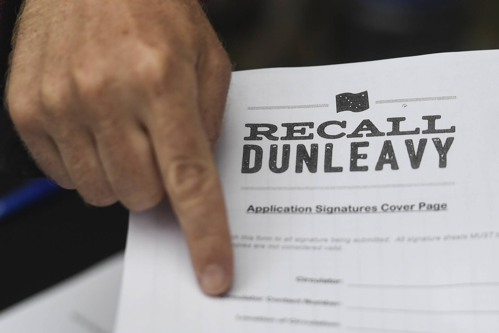 Juneau residents line up outside of the Planet Alaska Gallery to sign an application petition to recall Gov. Mike Dunleavy on Thursday, Aug. 1, 2019. (Michael Penn | Juneau Empire)