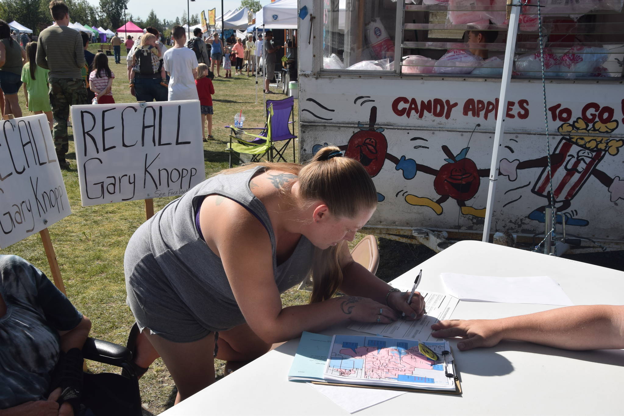 Brian Mazurek/Peninsula Clarion                                Denele McCarthy, of Soldotna, signs the petition Wednesday at Soldotna Creek Park to recall Rep. Gary Knopp, R-Soldotna.