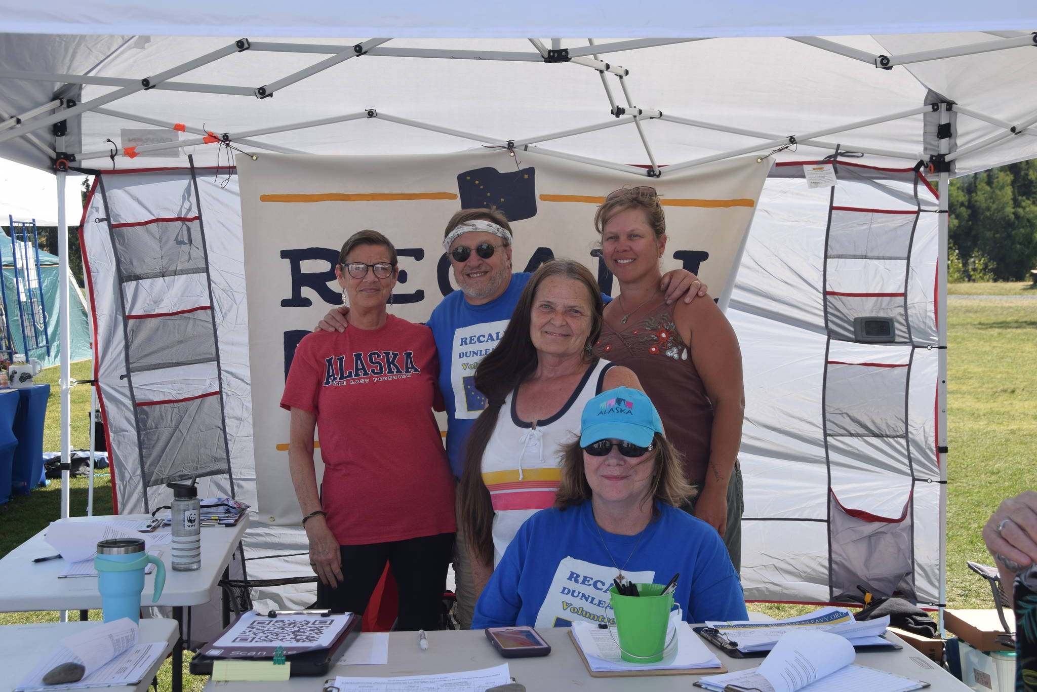 From left, Michele Vasquez, Eric Trieder, Fay Herold, Nelma Treider and Karyn Griffin smile for a photo while collecting signatures to recall Governor Mike Dunleavy in Soldotna Creek Park on Aug. 7, 2019. (Photo by Brian Mazurek/Peninsula Clarion)