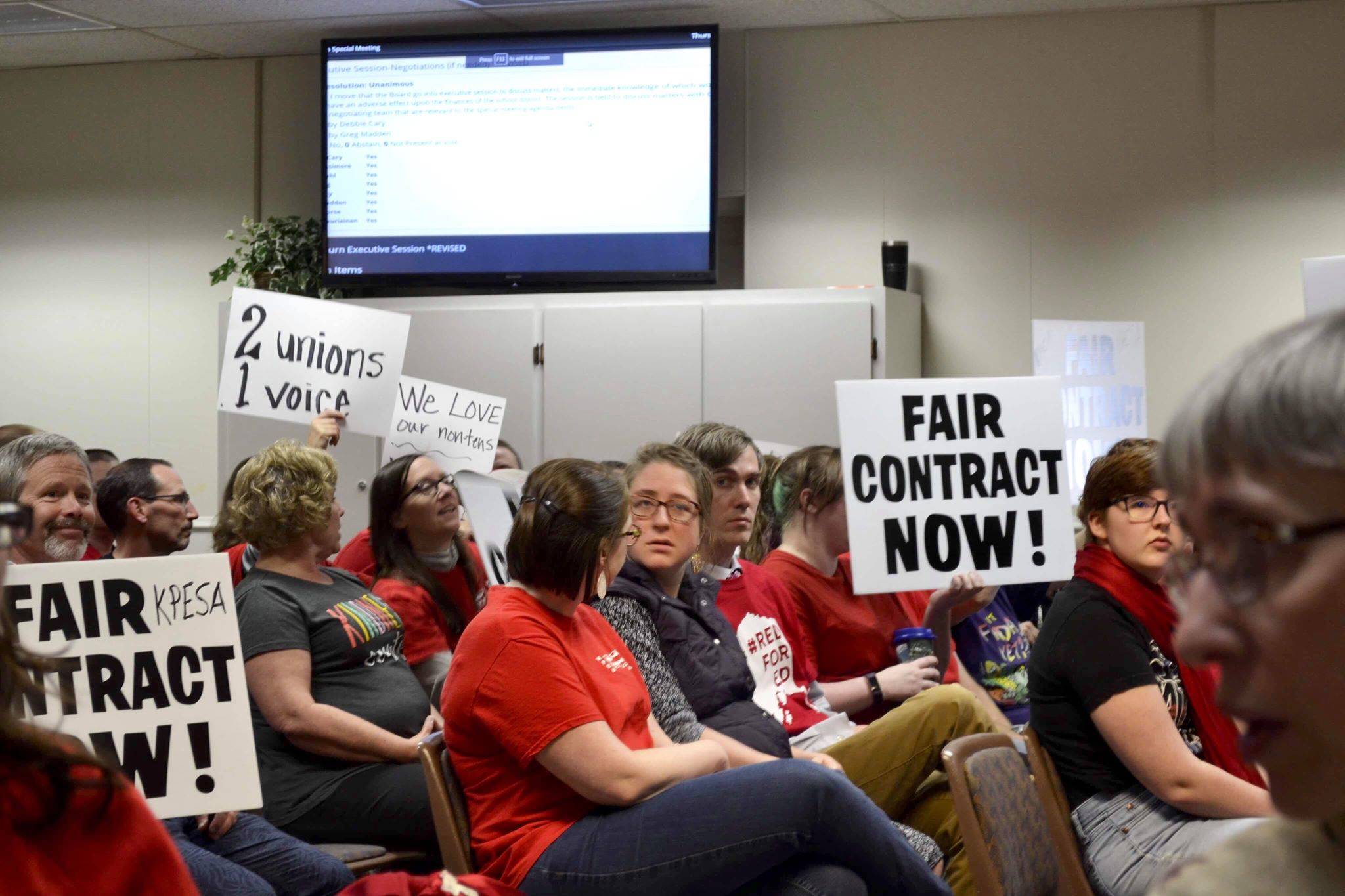 Kenai Peninsula Borough School District employees hold signs for a fair contract at Thursday’s special board of education meeting, May 16, 2019, In Soldotna, Alaska. (Photo by Victoria Petersen/Peninsula Clarion)