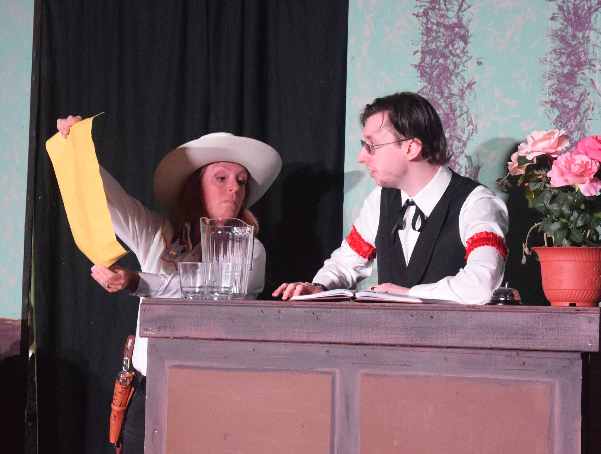 Tracie Stang (left) acts out a scene with Andrew Gunther during a rehearsel for Blazing Guns at Roaring Gulch held Thursday, Aug. 8, 2019, at the Kenai Performer’s stage in Soldotna. (Photo by Joey Klecka/Peninsula Clarion)