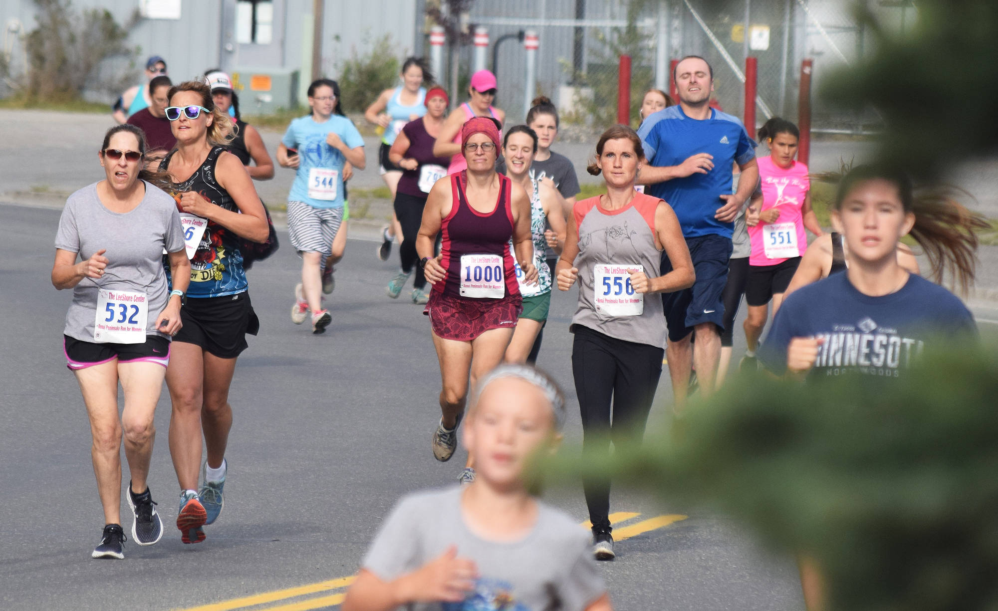 Deb Russ (532), Rachel Babbit (1000) and Tammy Fann (556) run with the pack early Saturday, Aug. 10, 2019, at the 32nd annual Run for Women in Kenai, Alaska. (Photo by Joey Klecka/Peninsula Clarion)