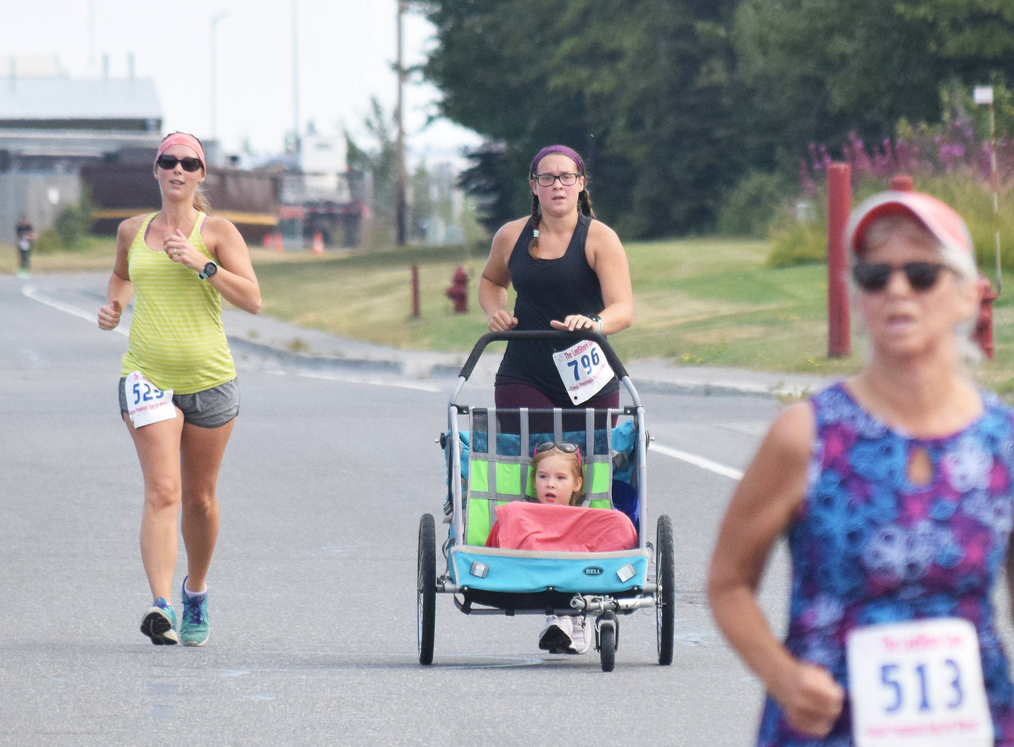 Maggie Nelson (left) and Mollie Pate approach the finish line for the 5K race Saturday, Aug. 10, 2019, at the 32nd annual Run for Women in Kenai, Alaska. (Photo by Joey Klecka/Peninsula Clarion)