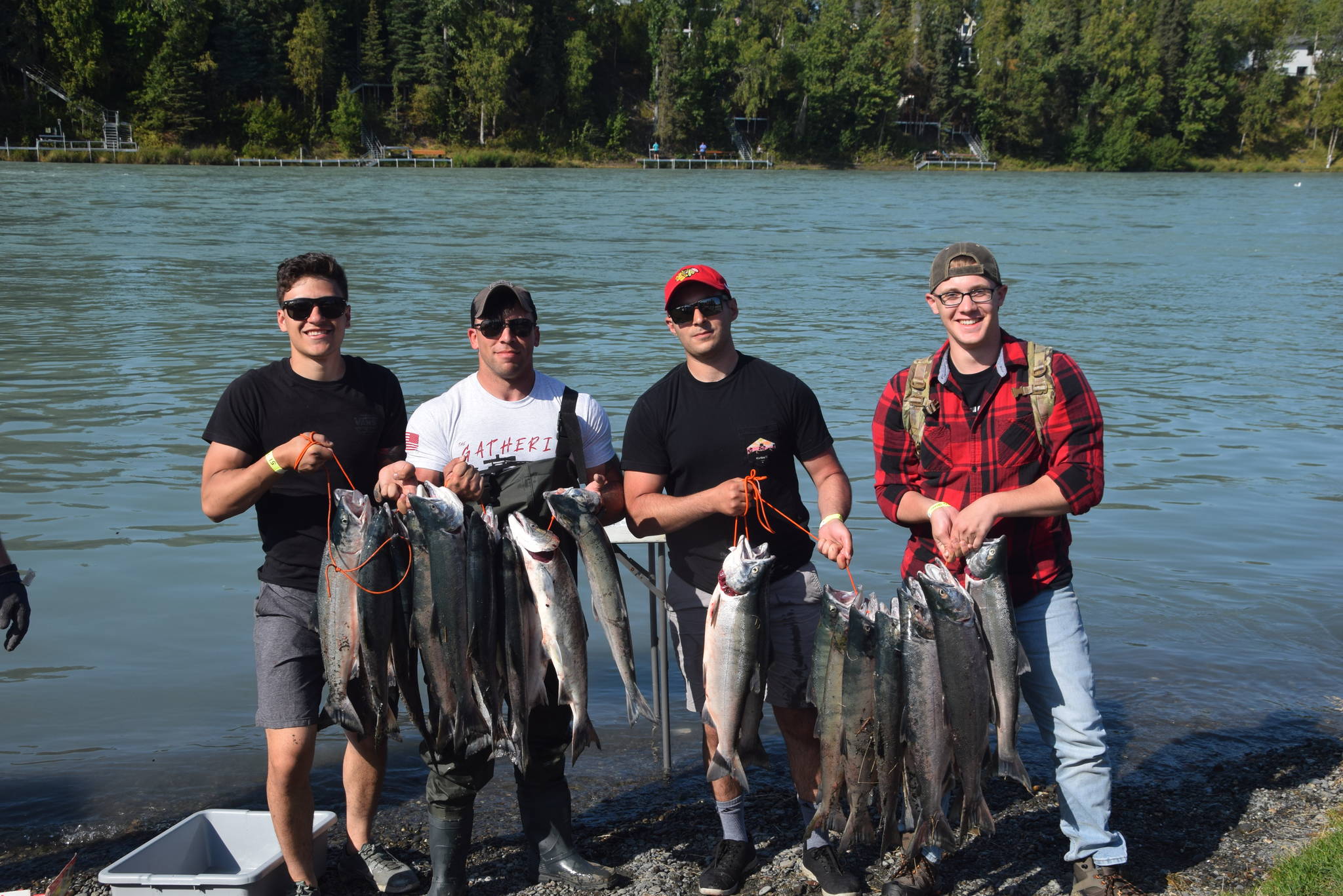 From left, Spc. Gabriel Rodriguez, Staff Sgt. David Wardlow, Spc. Tyler Vretenick and Spc. Ethan Holman show off the day’s haul during the Wounded Warrior’s Fishing Trip in Centennial Park in Soldotna, Alaska on Aug. 9, 2019. (Photo by Brian Mazurek)
