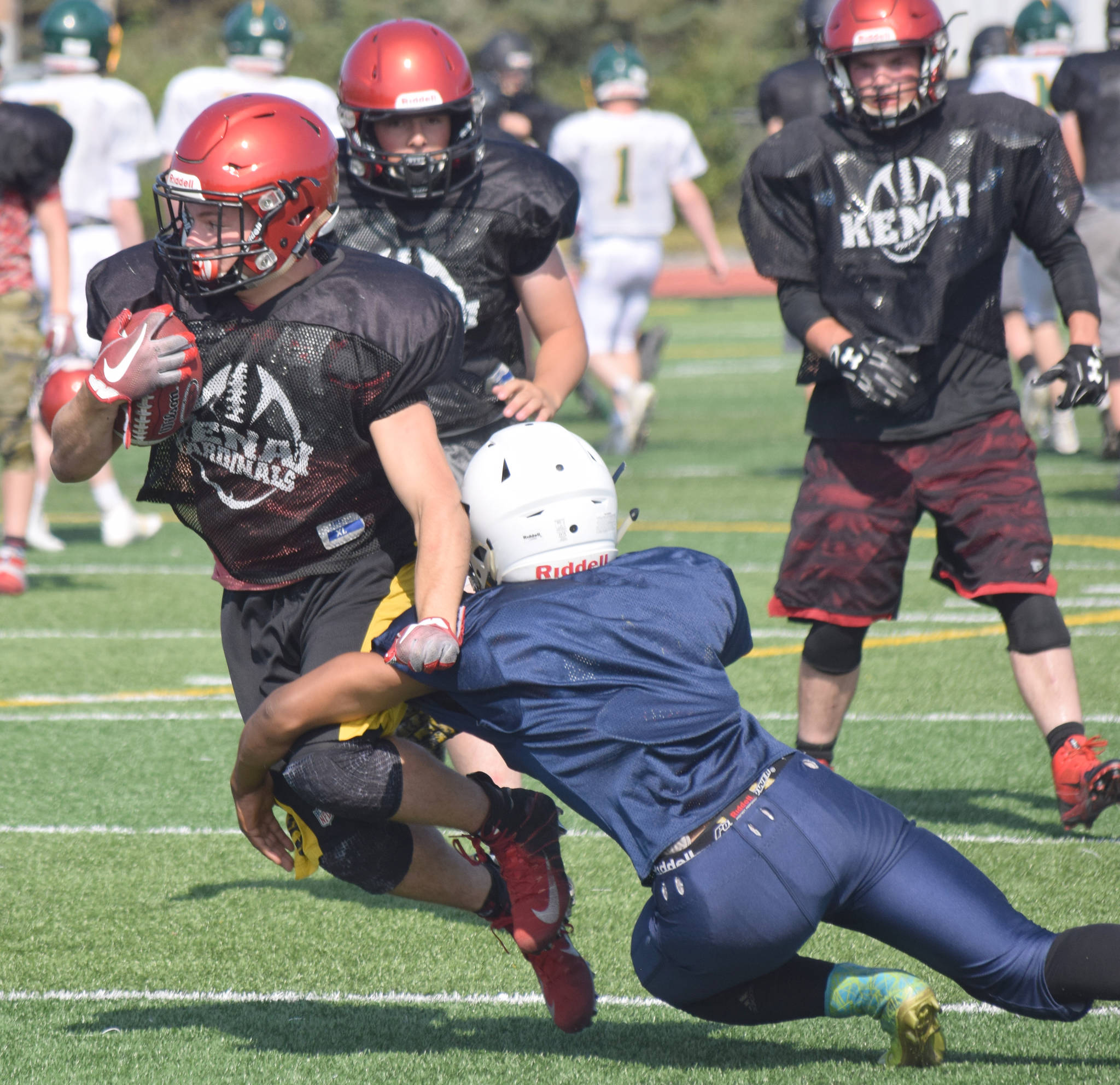 Zach Burnett of Kenai Central runs against Homer during a scrimmage Saturday, Aug. 10, 2019, at Ed Hollier Field in Kenai, Alaska. (Photo by Jeff Helminiak/Peninsula Clarion)