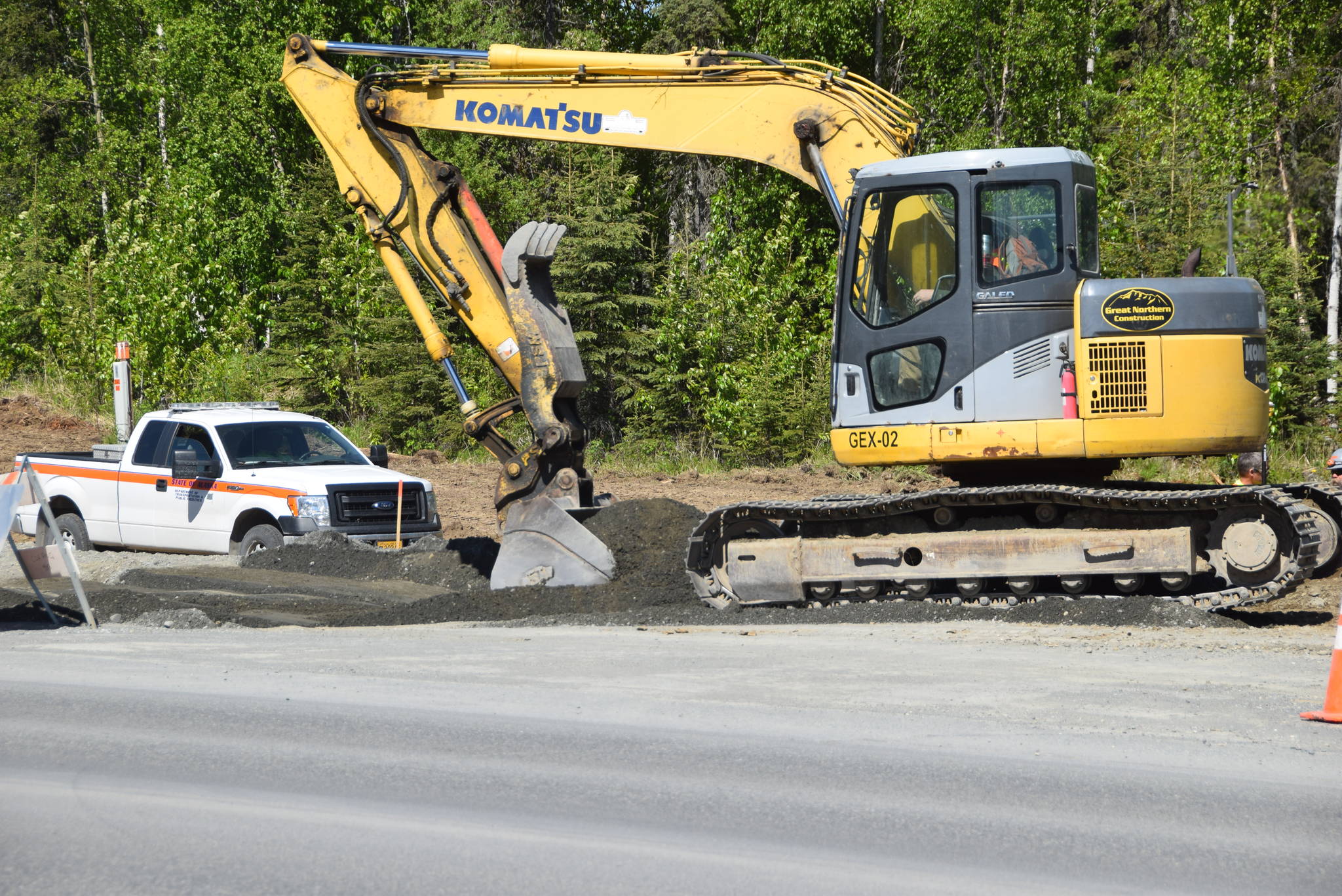 A construction crew excavates along the Kenai Spur Highway in Kenai, Alaska on June 4, 2019. (Photo by Brian Mazurek/Peninsula Clarion)