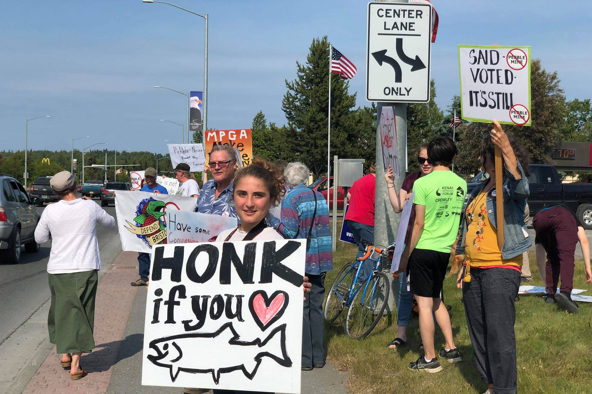 Residents line the Sterling Highway, in front of Sen. Lisa Murkowski’s office to oppose Pebble mine on Wednesday, June 26, 2019, in Soldotna, Alaska. (Photo by Victoria Petersen/Peninsula Clarion)