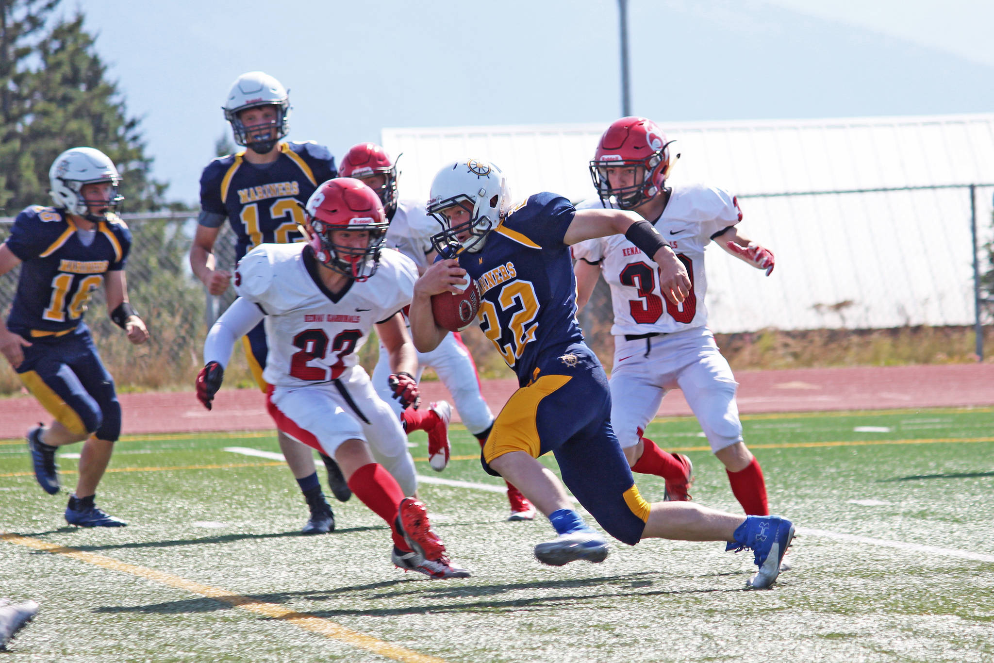 Kachemak-Selo senior and Homer runningback Antonin Maruchev looks for a place to go while under pressure from the Kenai Kardinals during a Saturday, Aug. 17, 2019 football game at Homer High School in Homer, Alaska. (Photo by Megan Pacer/Homer News)