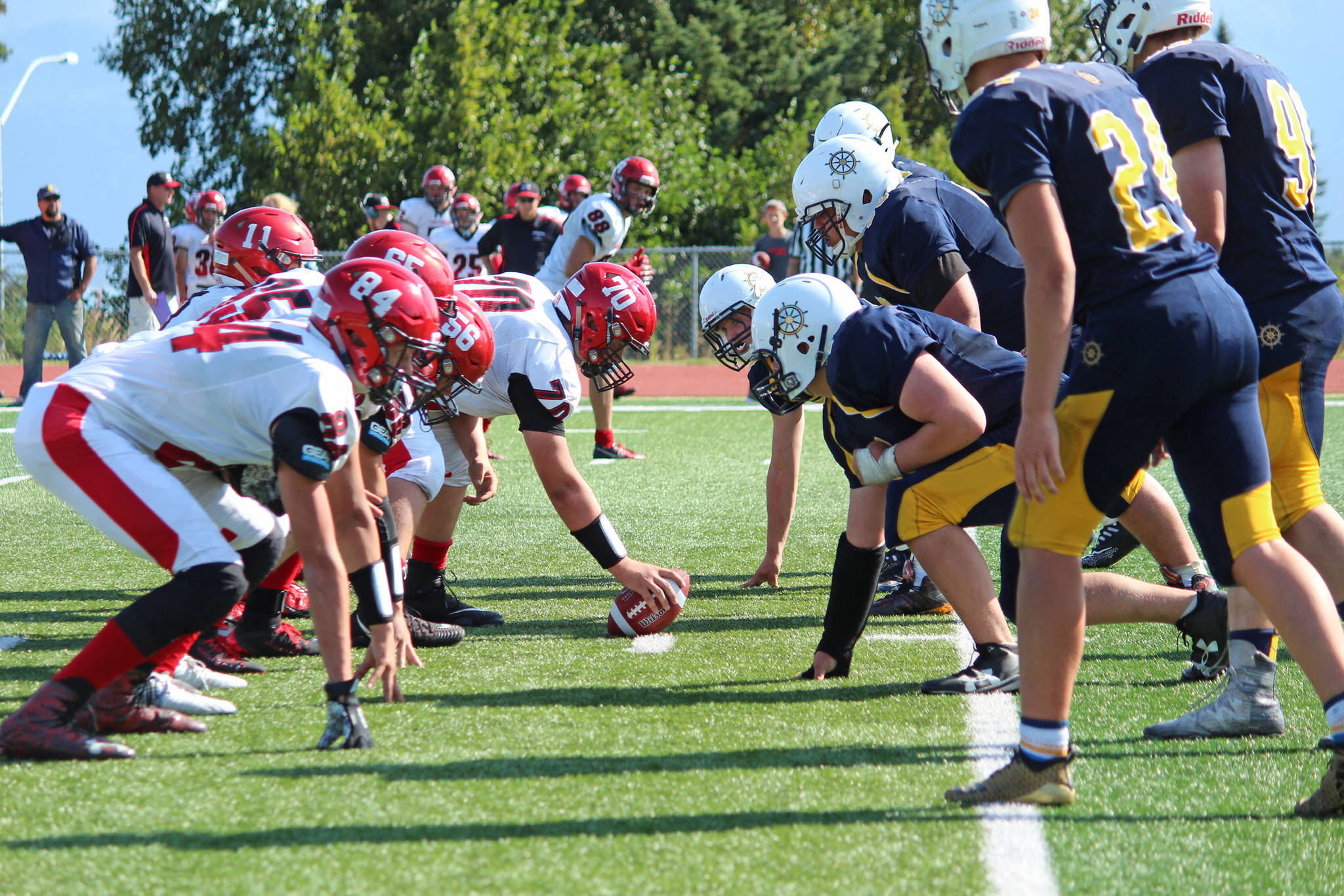 The Kenai Kardinals (left) and Homer Mariners face off against each other in their first varsity football game on the season Saturday, Aug. 17, 2019 in Homer, Alaska. (Photo by Megan Pacer/Homer News)