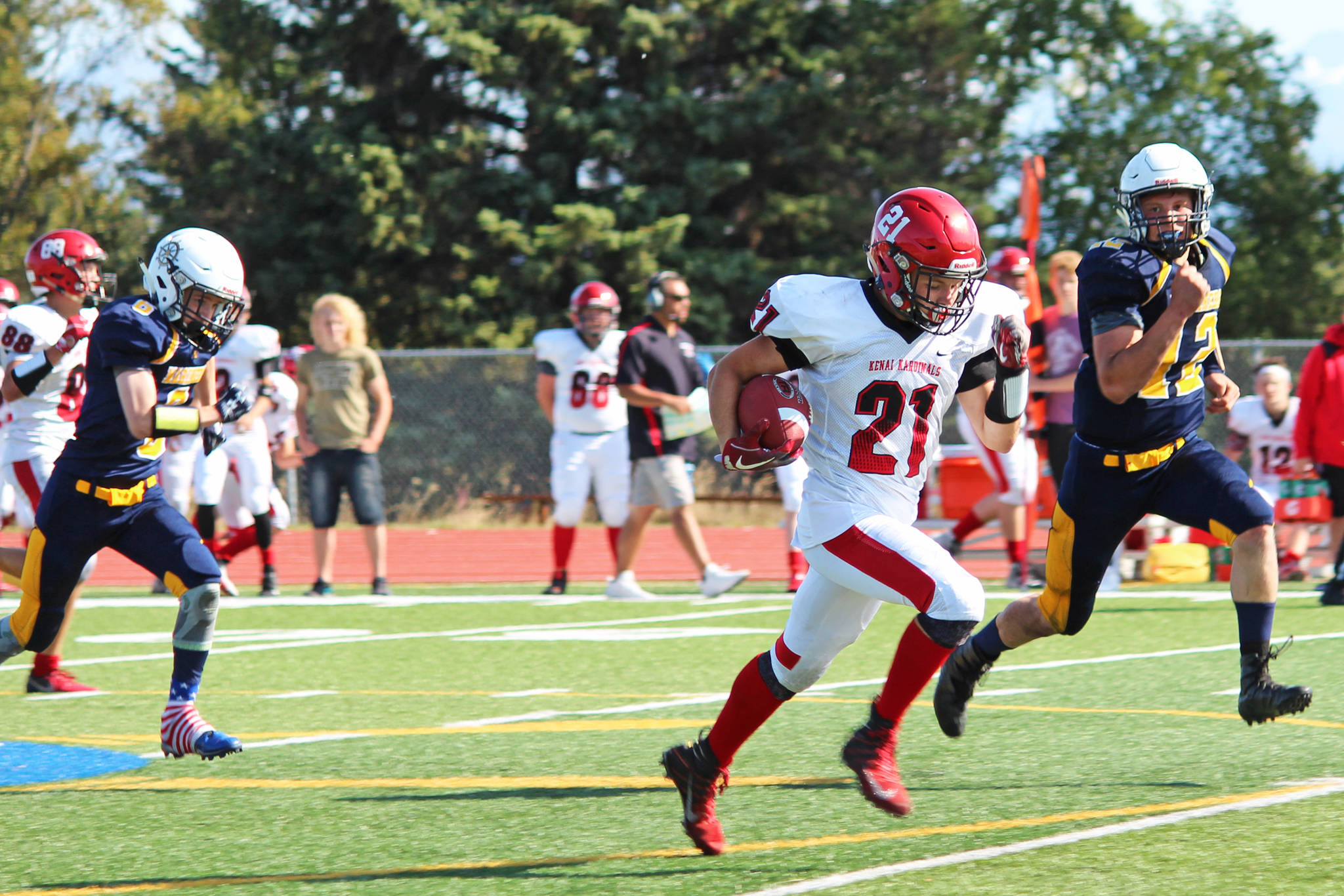 Kenai Central High School senior Zach Burnett breaks away from the Homer defense to make a 62-yard run and touchdown for the Kardinals during a Saturday, Aug. 17, 2019 football game at the Mariner field in Homer, Alaska. (Photo by Megan Pacer/Homer News)
