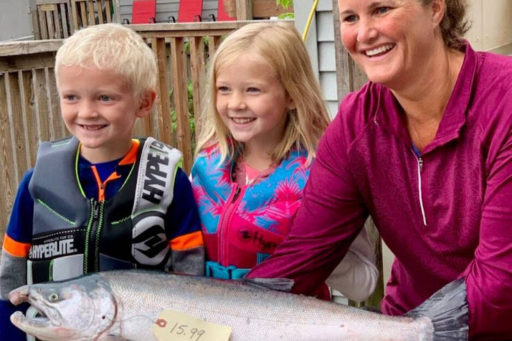 Michelle Murray, of Eagle River, and her two children show off the 2019 Seward Silver Salmon Derby winning fish caught at the head of Resurrection Bay on the F/V Joe Legacy. Murray took home a $10,000 prize for largest fish. (Photo courtesy of Seward Chamber of Commerce)