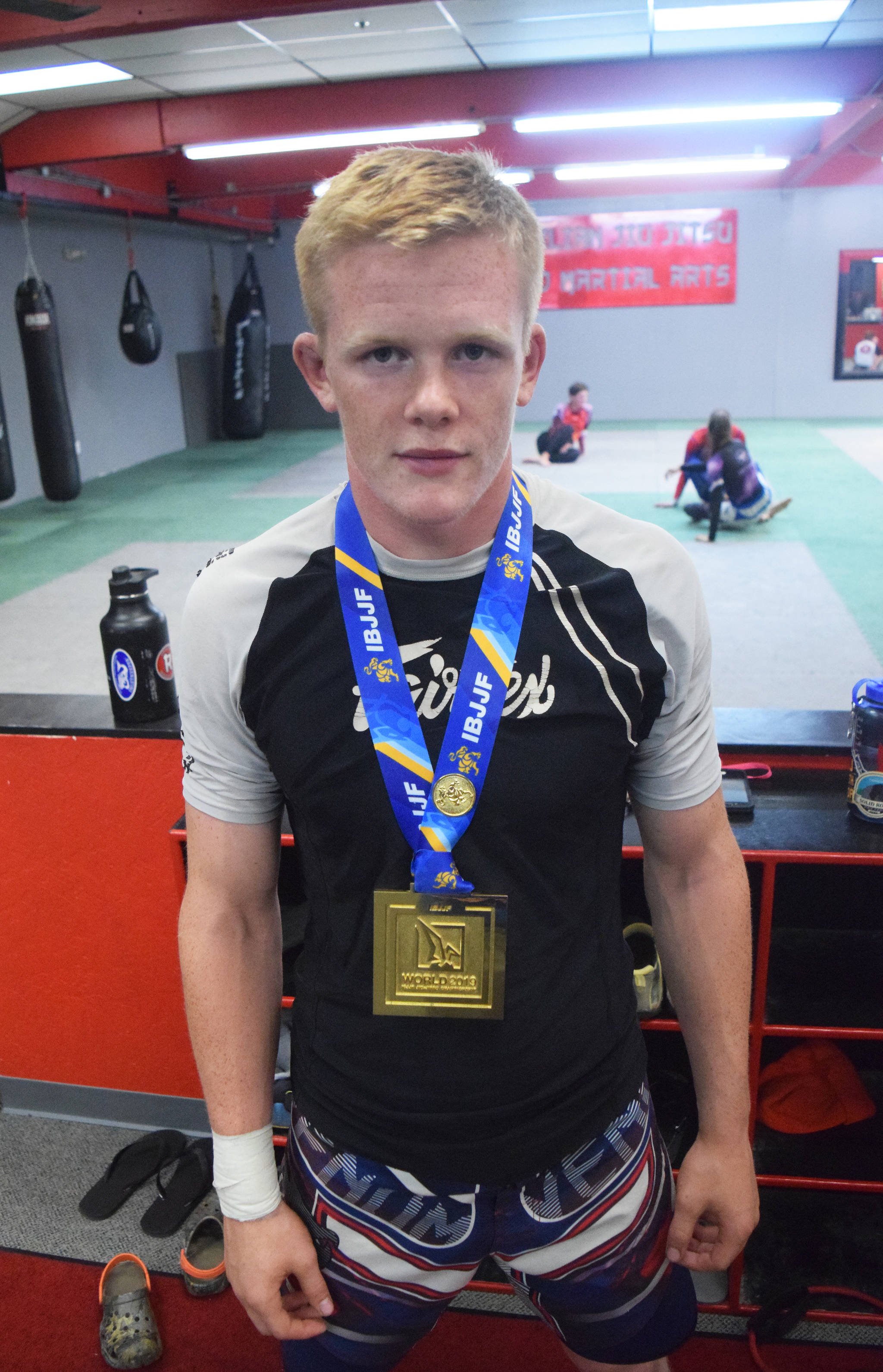 Soldotna’s Sean Babitt stands with his first-place medal Thursday at Redemption MMA. Babitt won a division title at the IBJJF World Championships June 1 in Long Beach, California. (Photo by Joey Klecka/Peninsula Clarion)