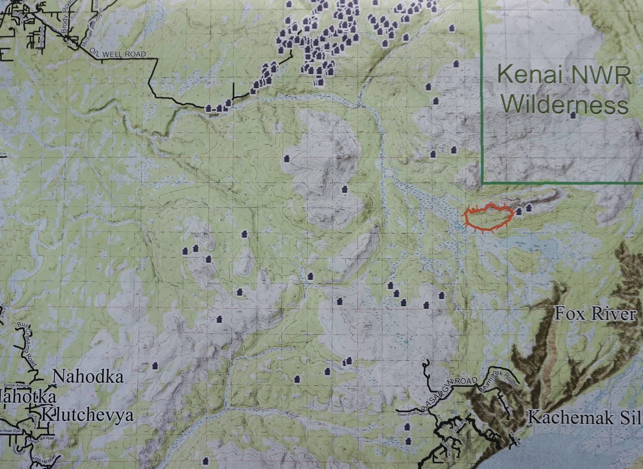 A map shows the Caribou Lake Fire, in red, in relationship to nearby communities and cabins. It was part of a community meeting held on Saturday, Aug. 24, 2019, at a McNeil Canyon Elementary School near Fritz Creek, Alaska. (Photo by Michael Armstrong/Homer News)