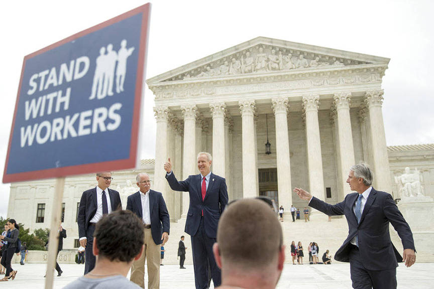 Illinois Gov. Bruce Rauner gives a thumbs up outside the Supreme Court, Wednesday, June 27, 2018 in Washington. From left are, Liberty Justice Center’s Director of Litigation Jacob Huebert, plaintiff Mark Janus, Rauner, and Liberty Justice Center founder and chairman John Tillman. The Supreme Court ruled that government workers can’t be forced to contribute to labor unions that represent them in collective bargaining, dealing a serious financial blow to organized labor. (AP Photo | Andrew Harnik)